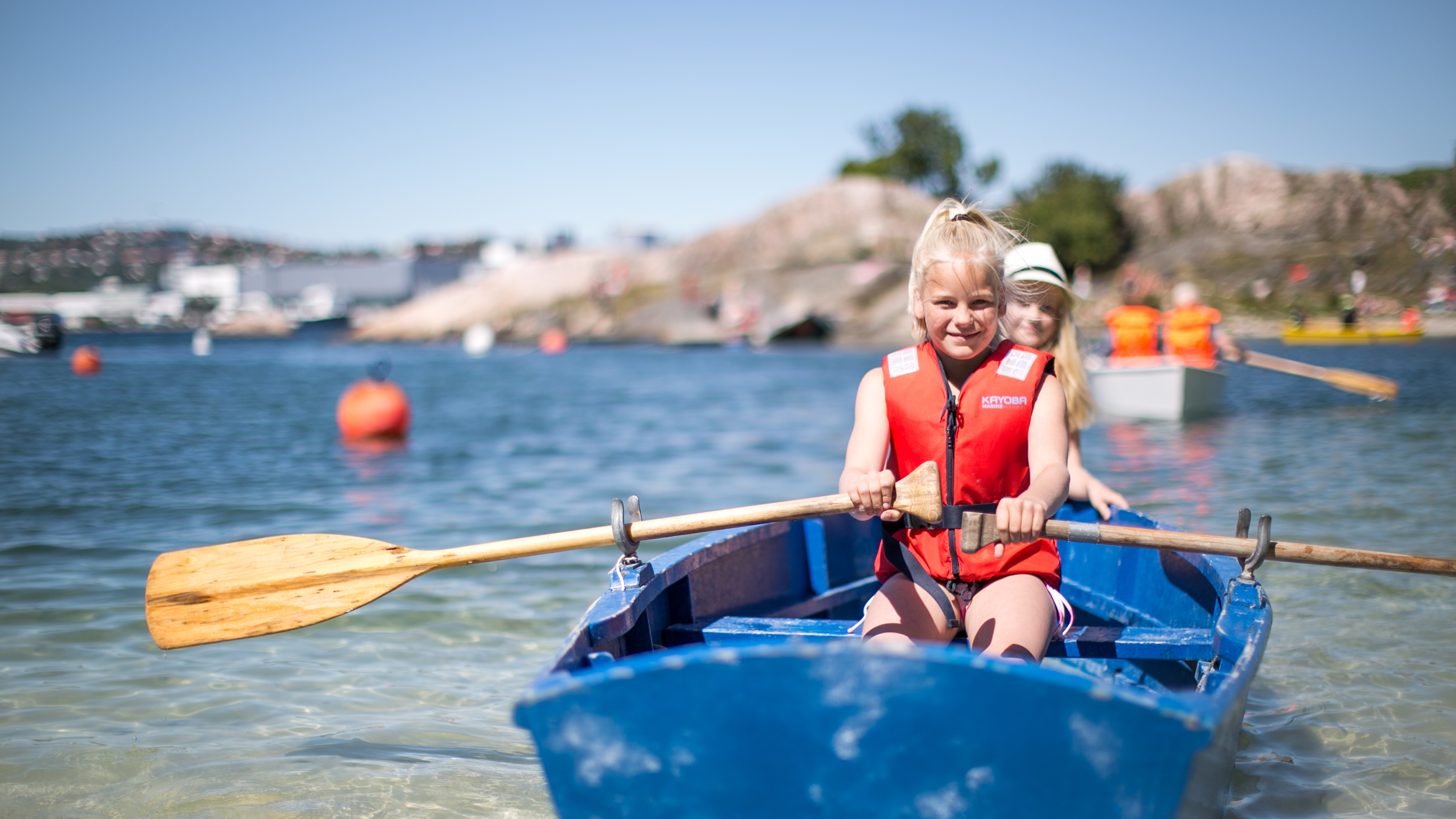 Two children in a rowing boat near Bragdøya outside of Kristiansand, Southern Norway