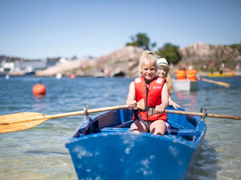 Two children in a rowing boat near Bragdøya outside of Kristiansand, Southern Norway