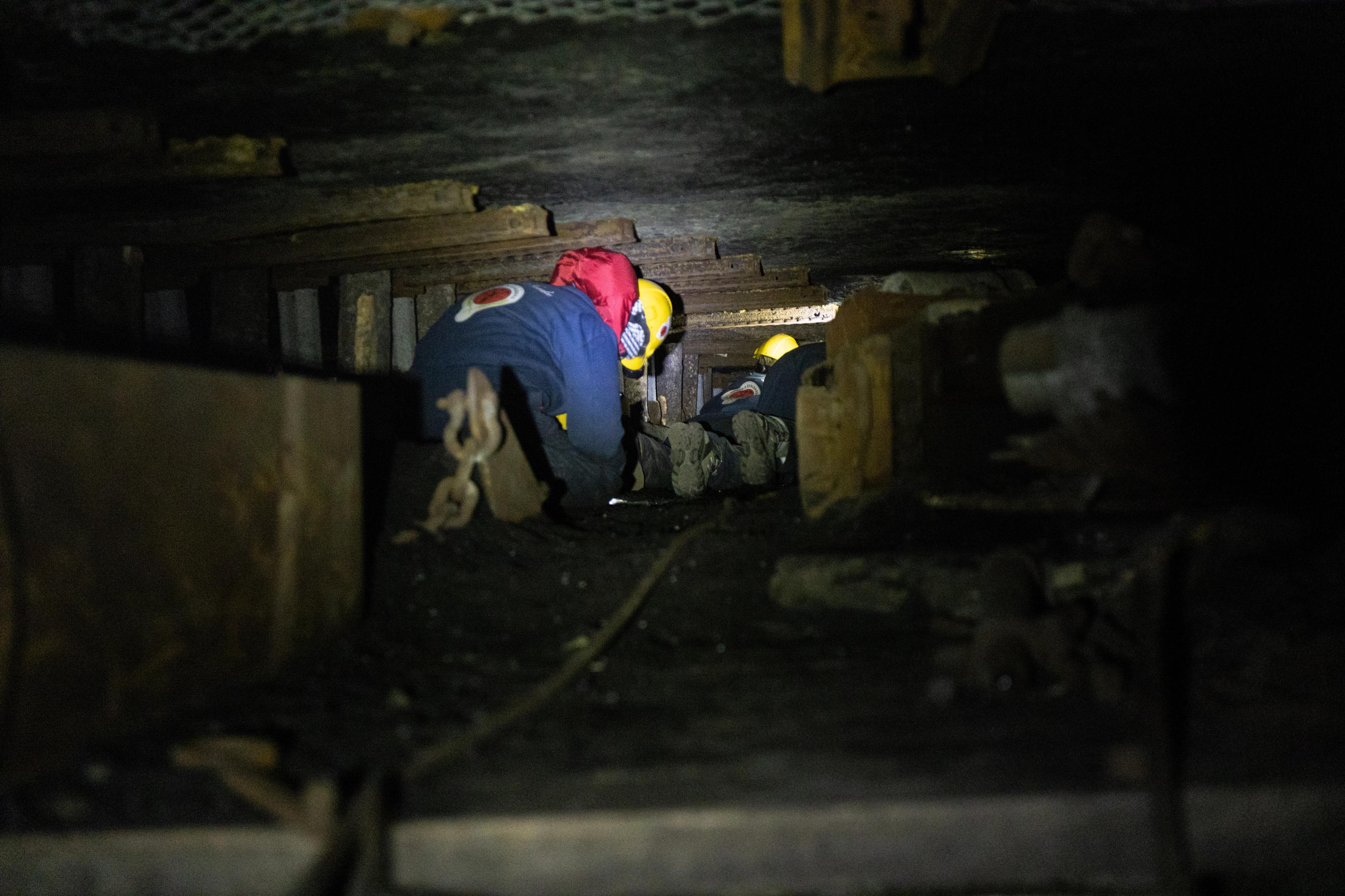 Person climbing in the narrow coal mines at Svalbard, Northern Norway