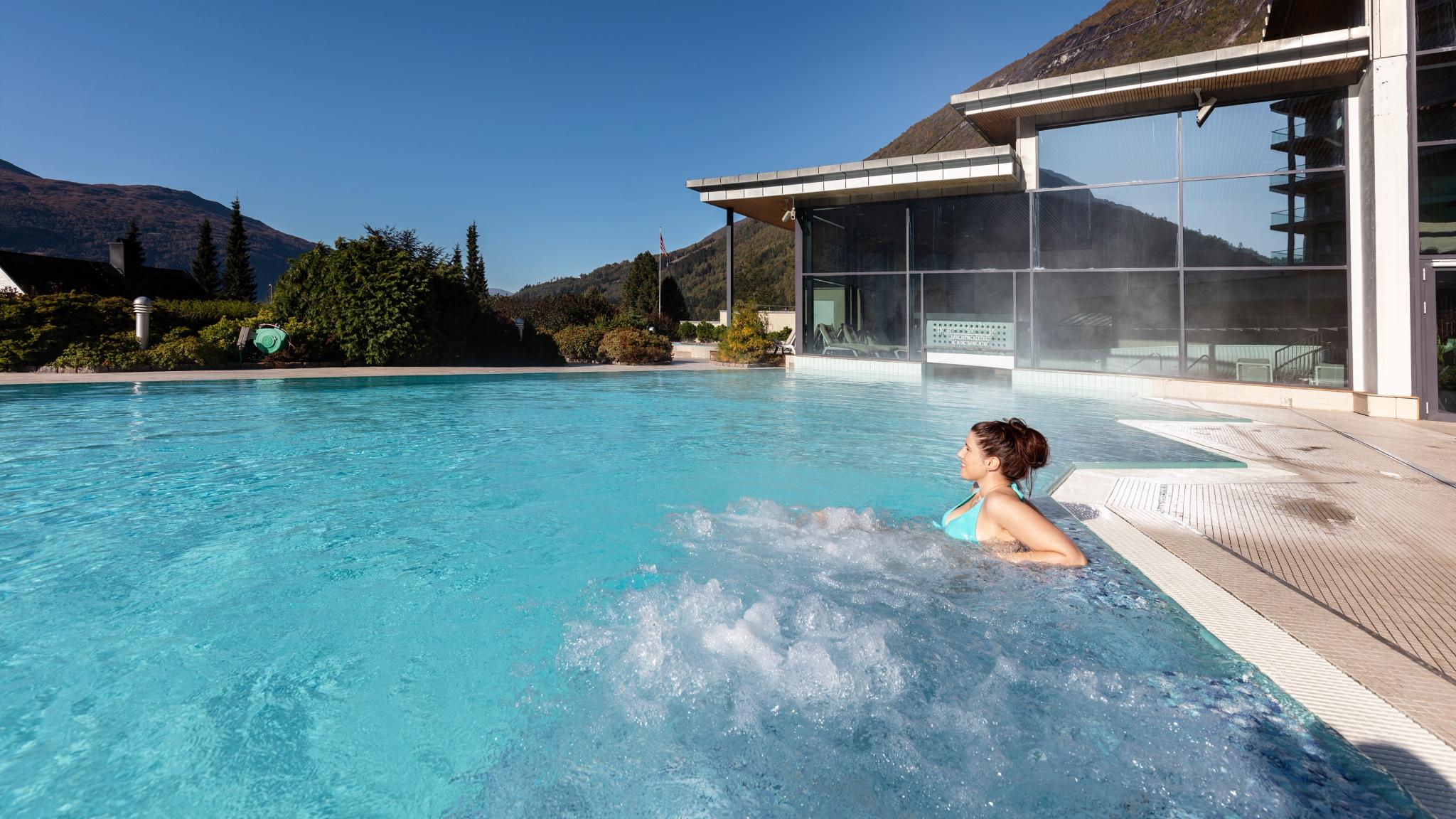A woman is relaxing in the pool at Hotel Alexandra in Stryn in Nordfjord, Fjord Norway