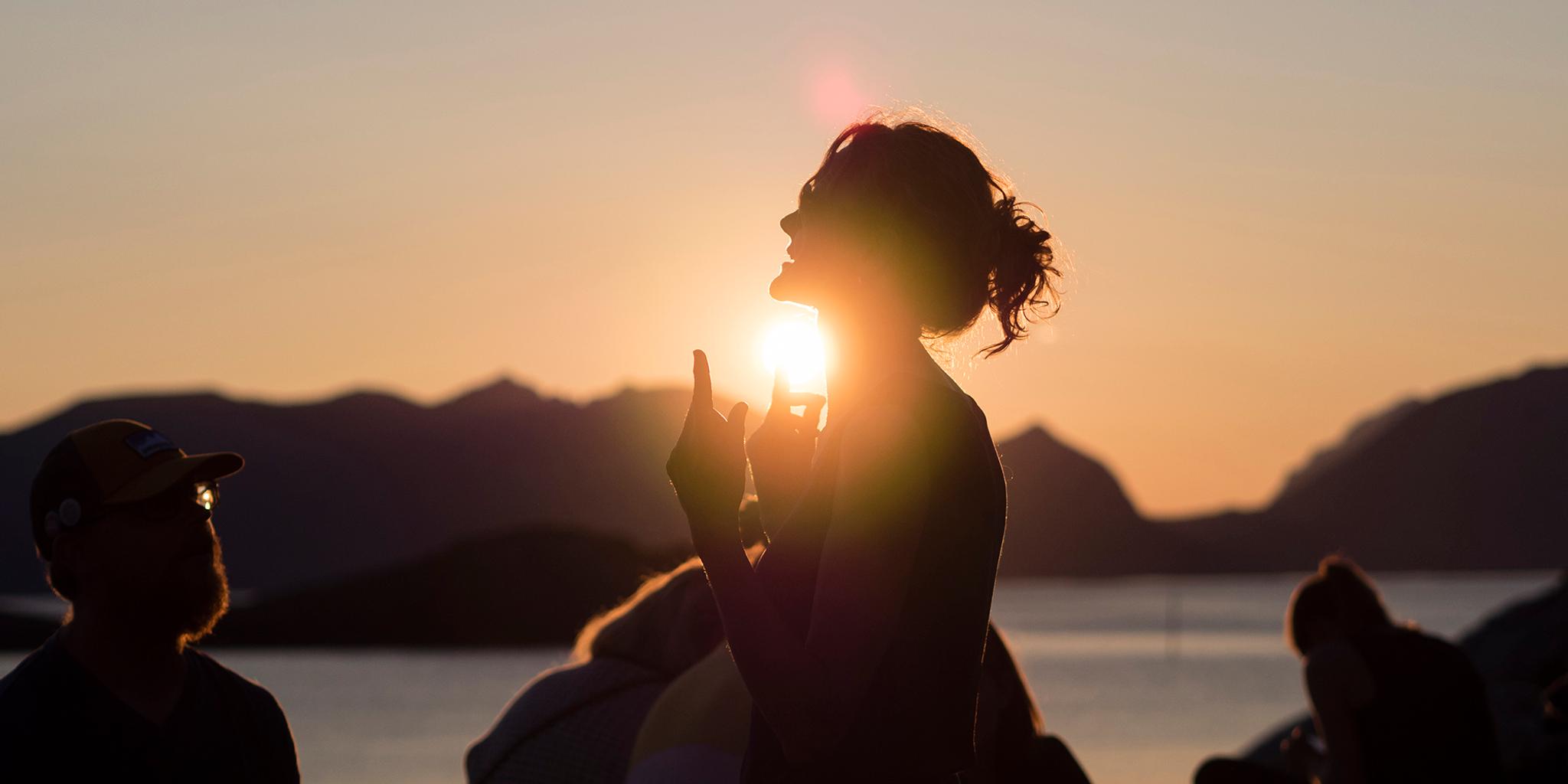 People attending the Trevarefest festival under the midnight sun in Henningsvær, Northern Norway