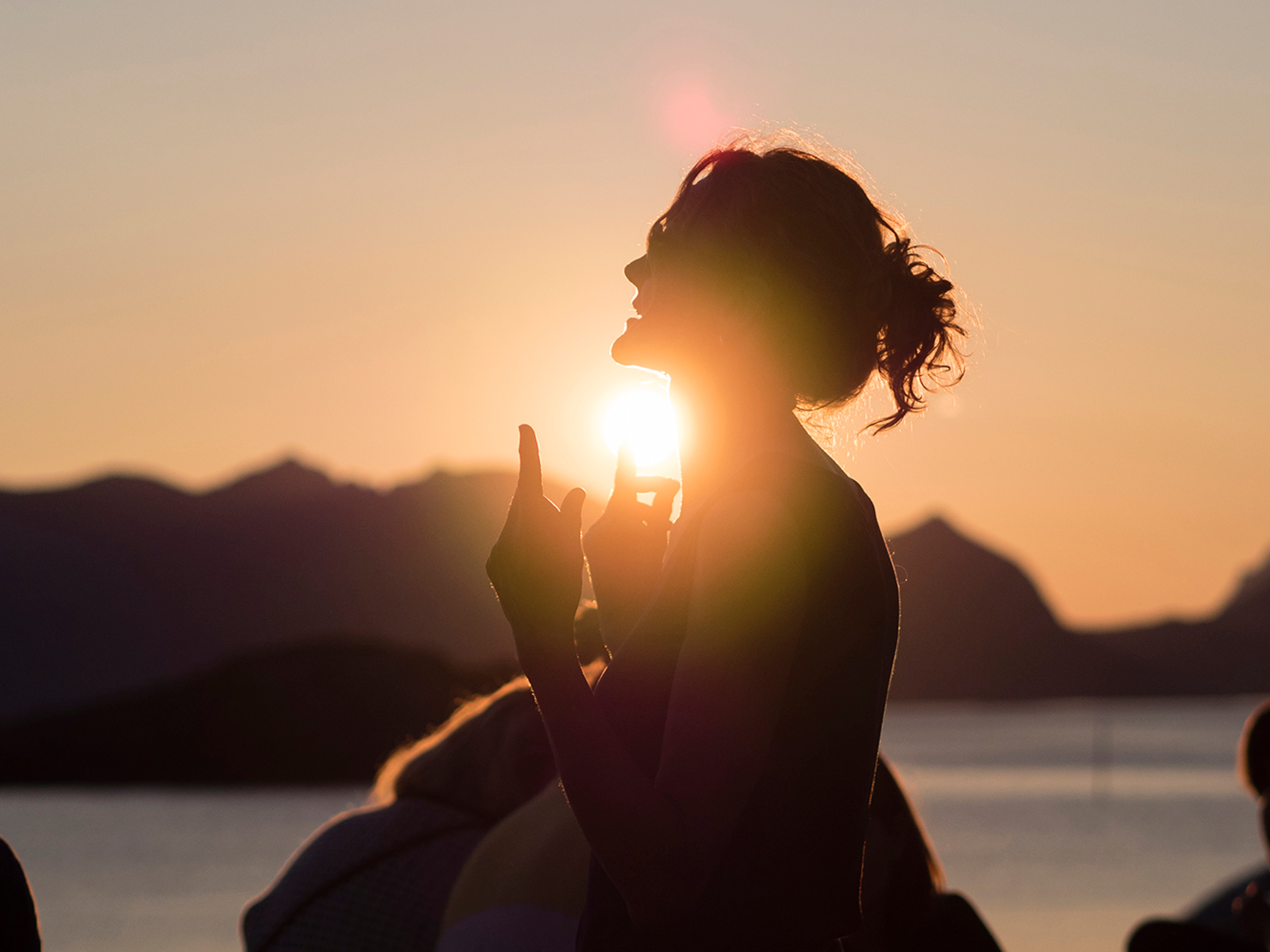 People attending the Trevarefest festival under the midnight sun in Henningsvær, Northern Norway