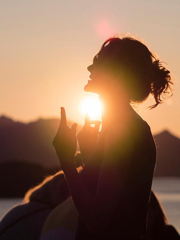 People attending the Trevarefest festival under the midnight sun in Henningsvær, Northern Norway