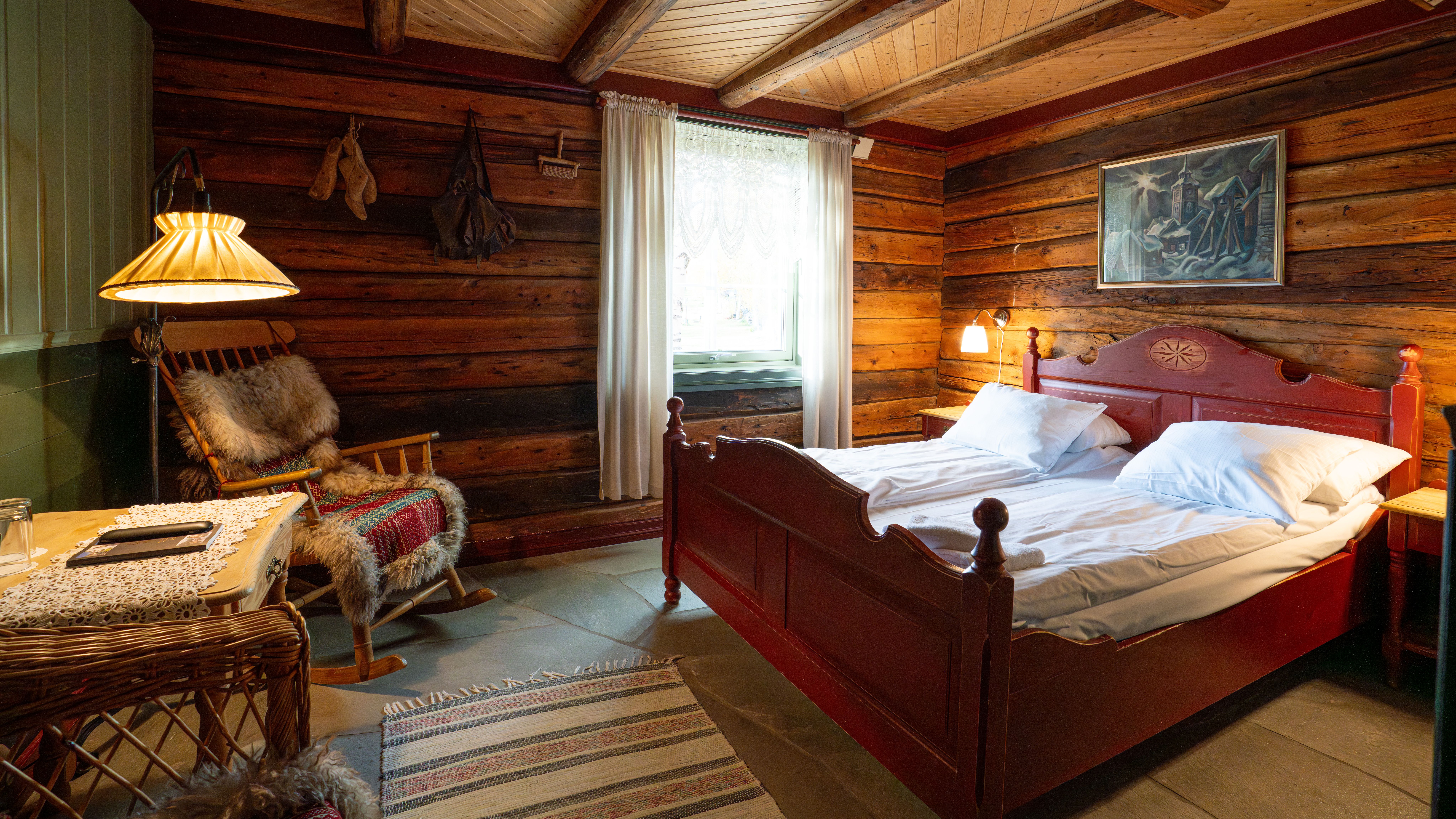 A historic hotel room with wooden panelling and furniture.
