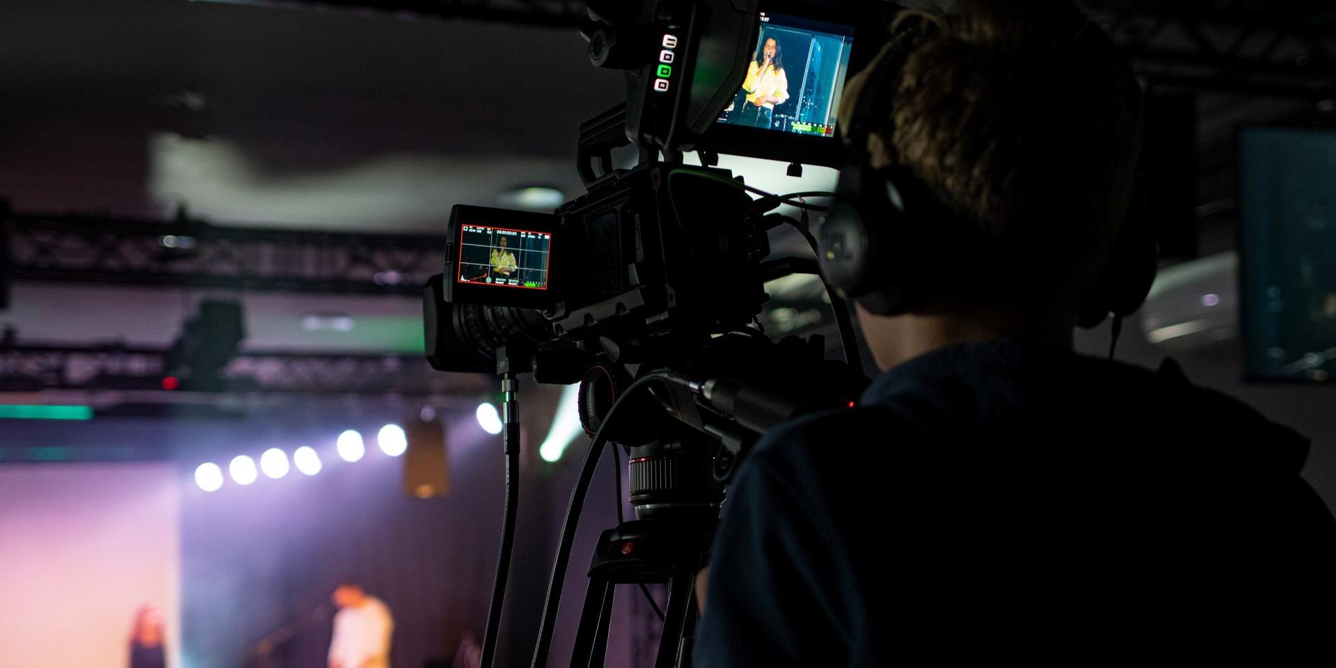 A person with a camera recording a conference at one of the Thon Hotels in Norway