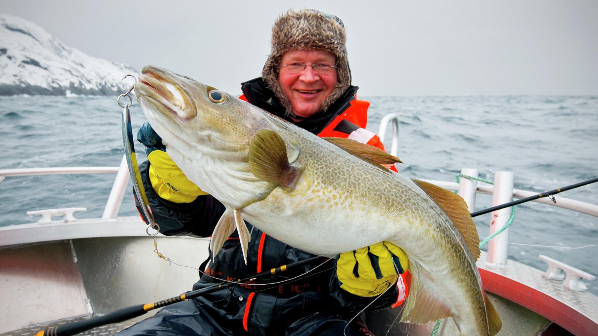 A many is very happy after a big catch.