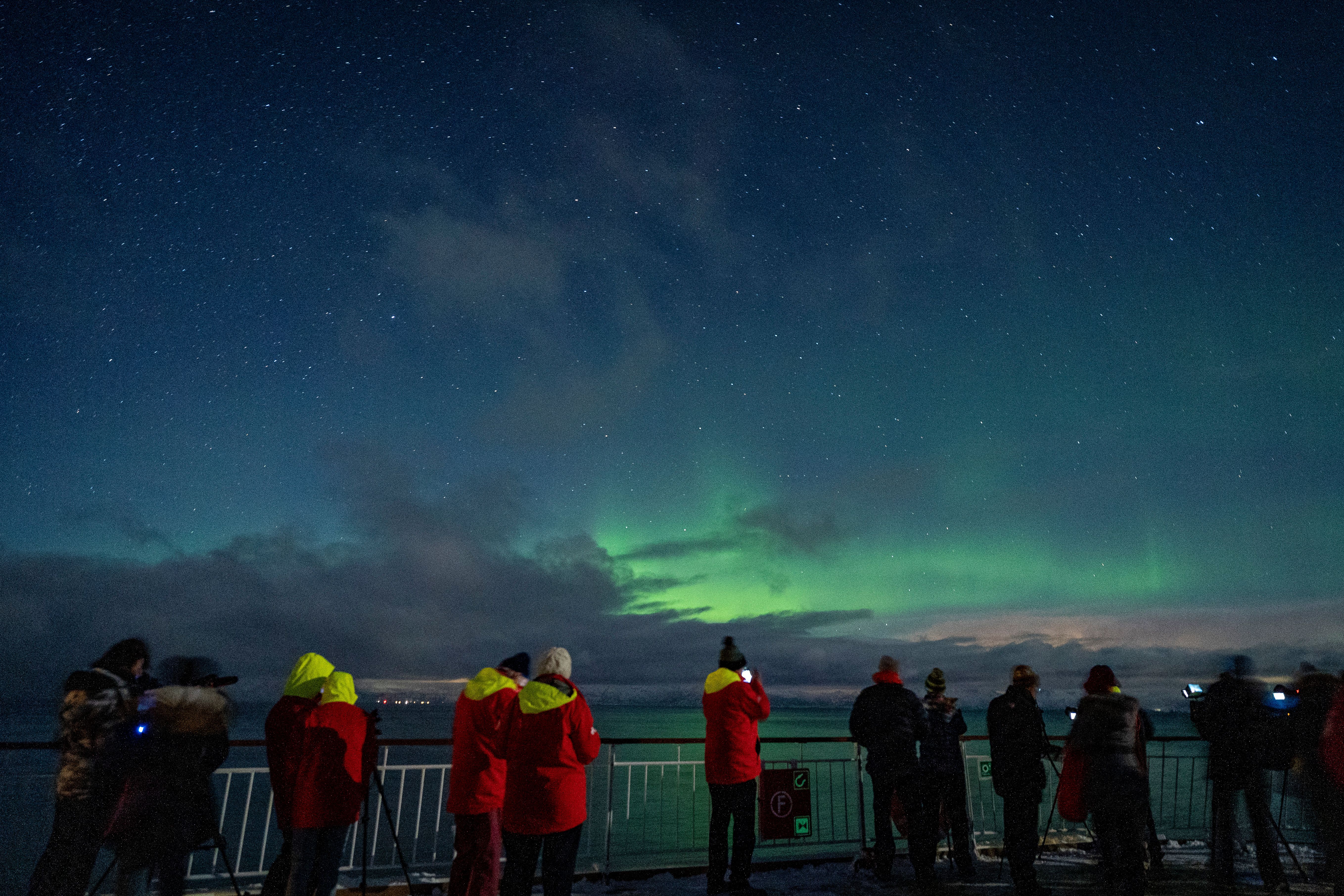 People watching Aurora Borealis at Hurtigruten