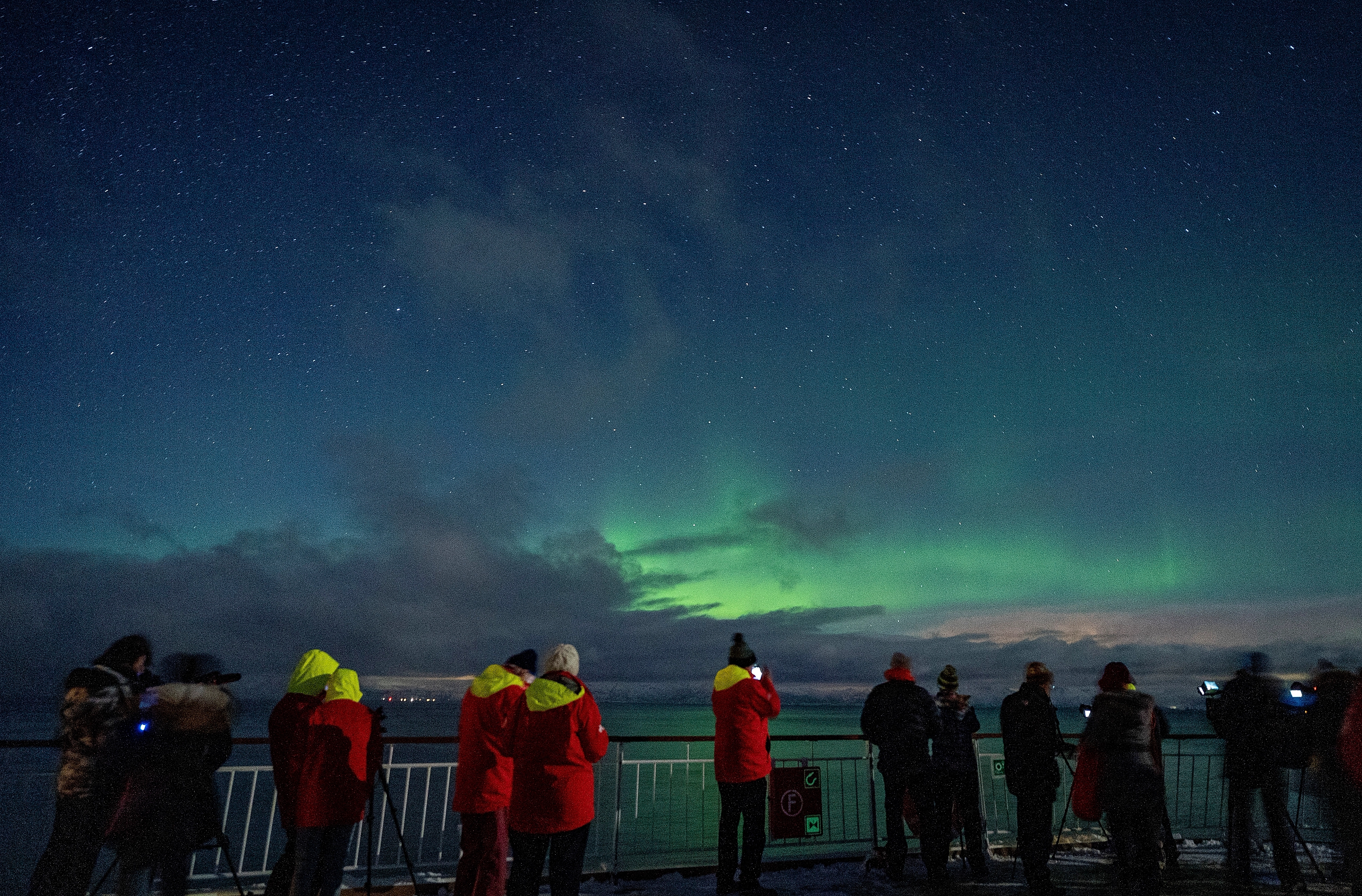 People watching Aurora Borealis at Hurtigruten
