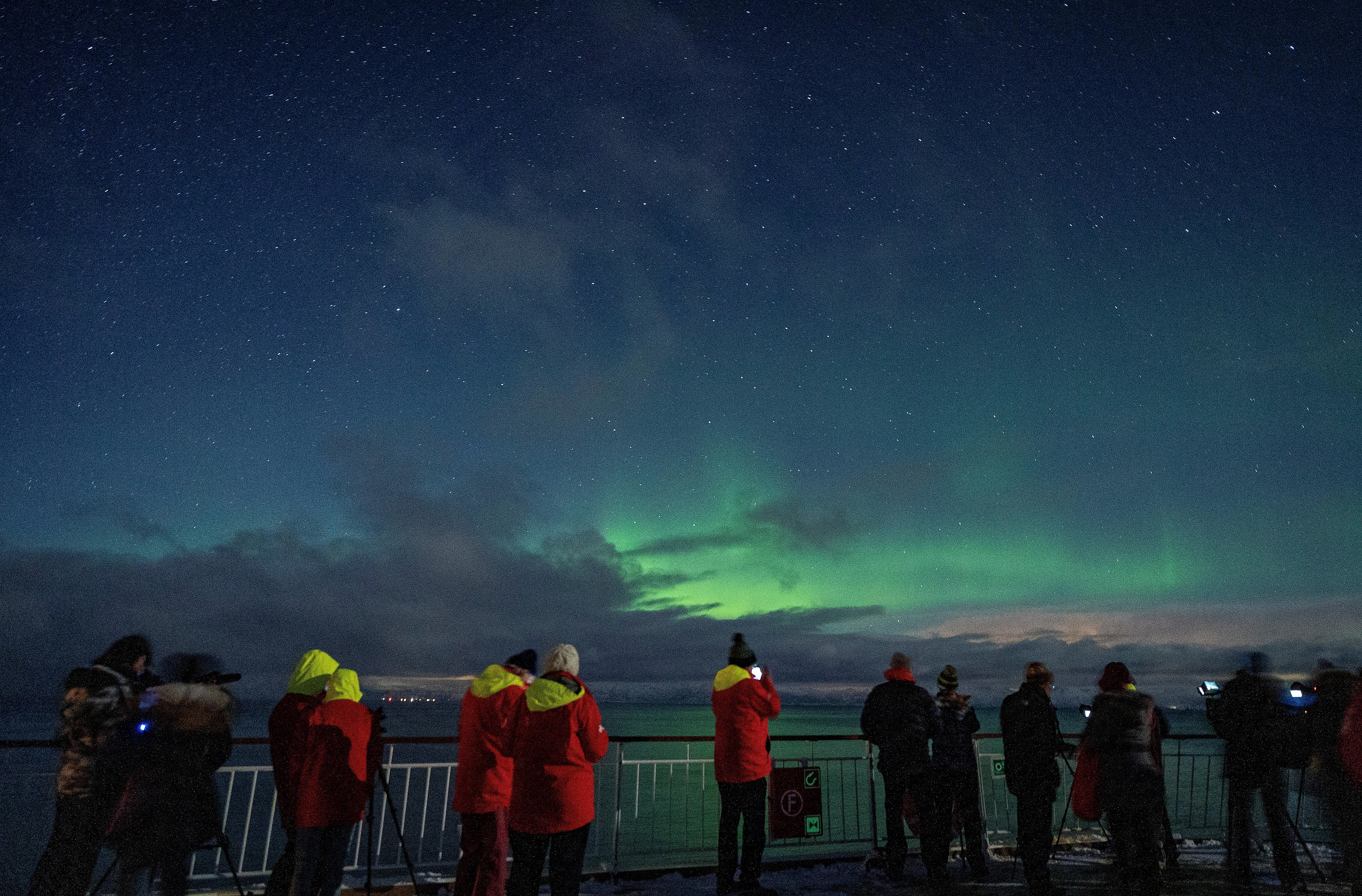 People watching Aurora Borealis at Hurtigruten