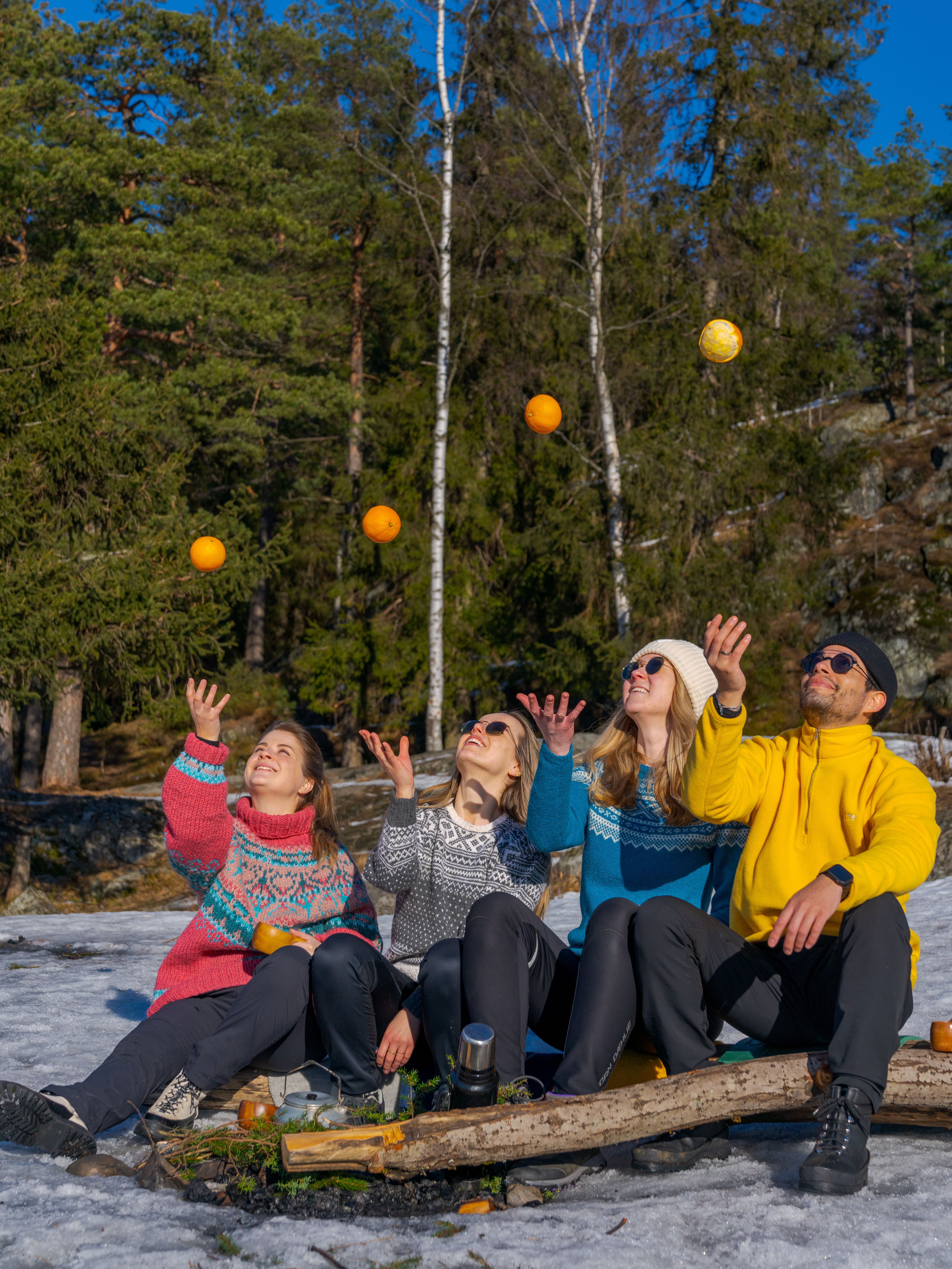 Friends playing with oranges at Grefsenkollen viewpoint