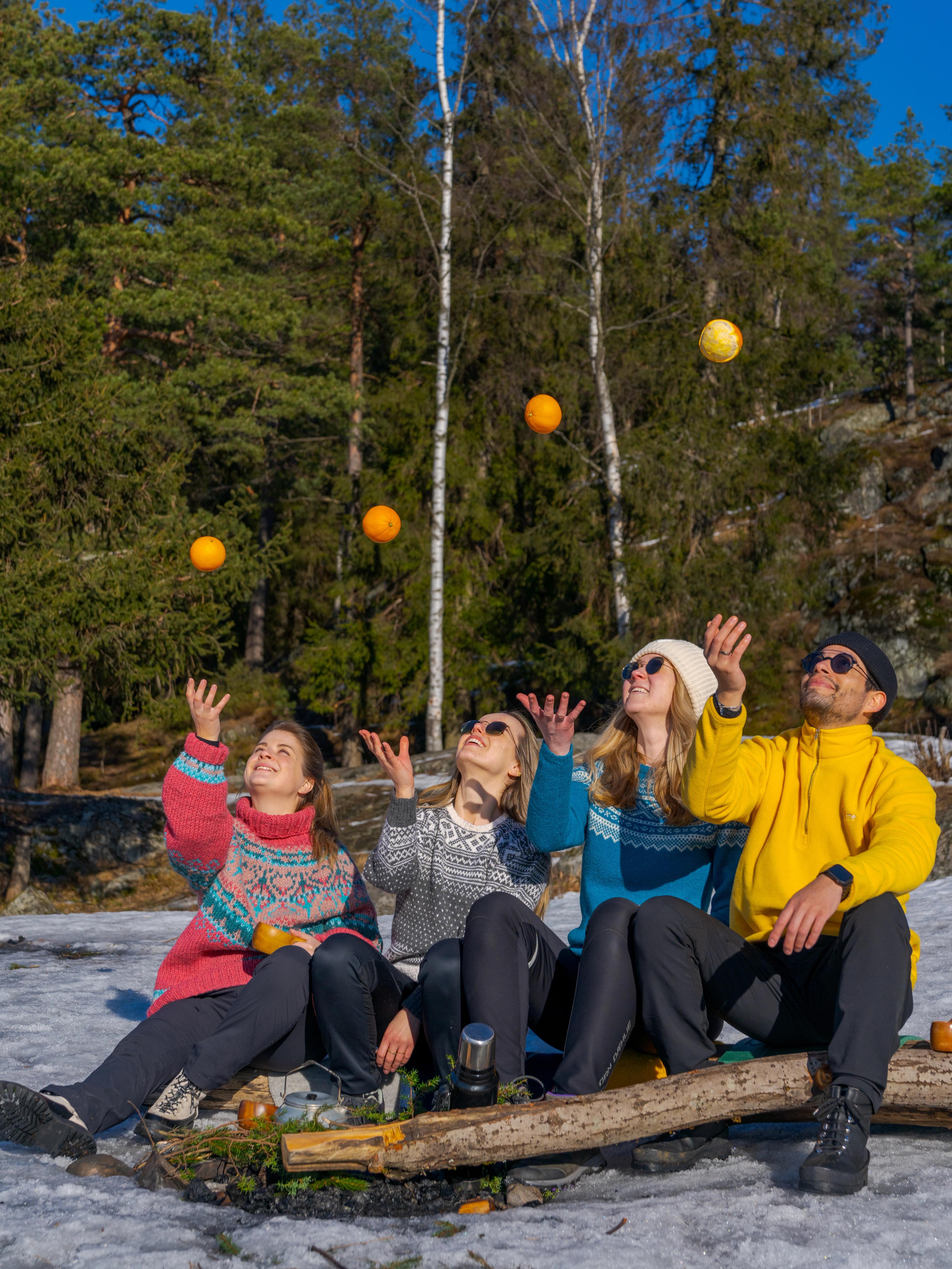 Friends playing with oranges at Grefsenkollen viewpoint