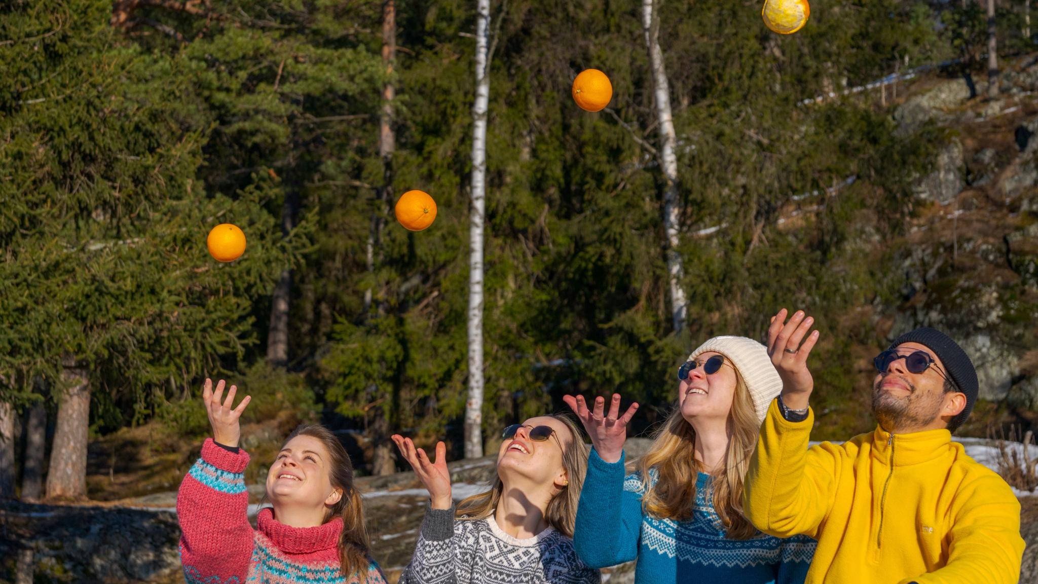 Friends playing with oranges at Grefsenkollen viewpoint