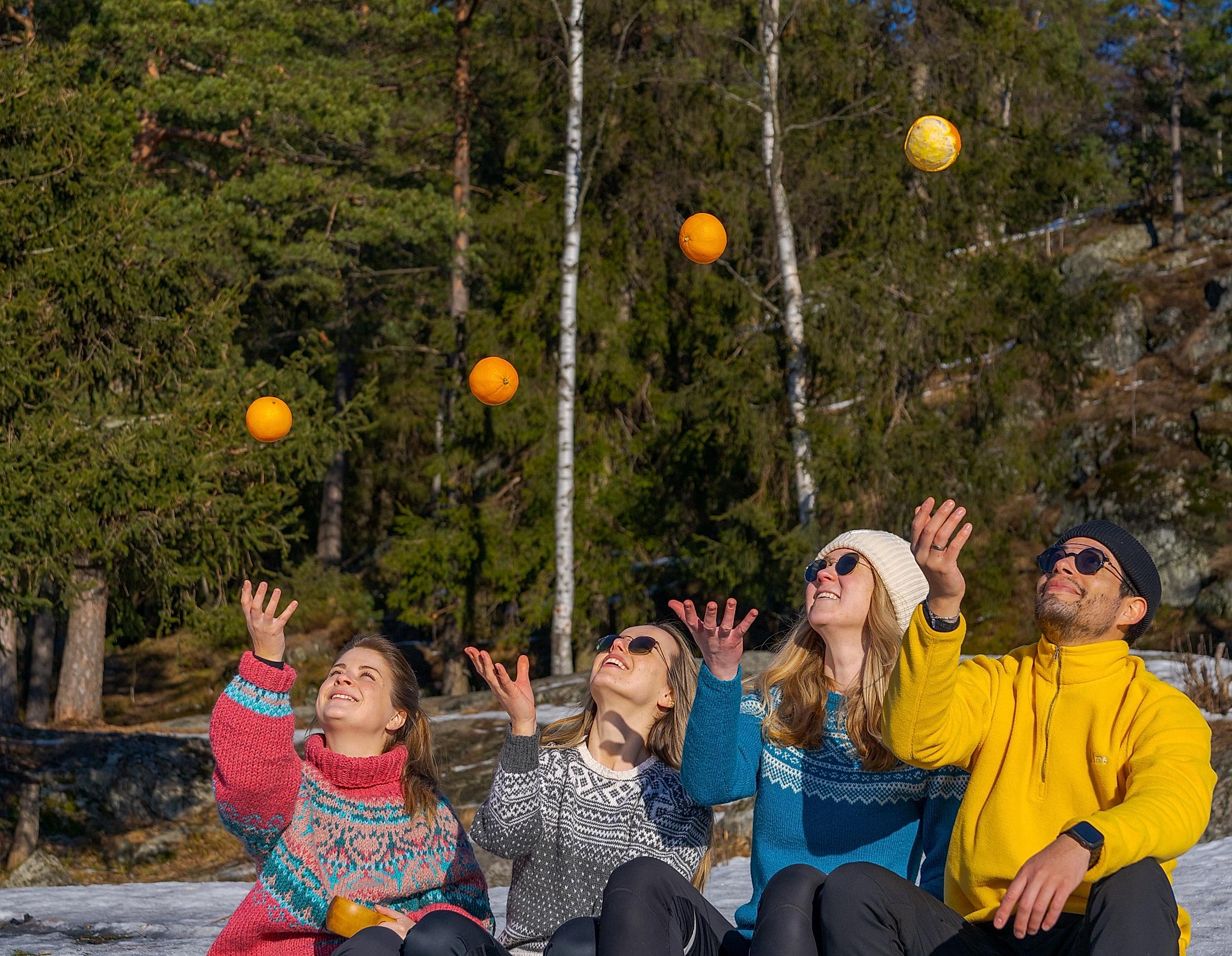 Friends playing with oranges at Grefsenkollen viewpoint