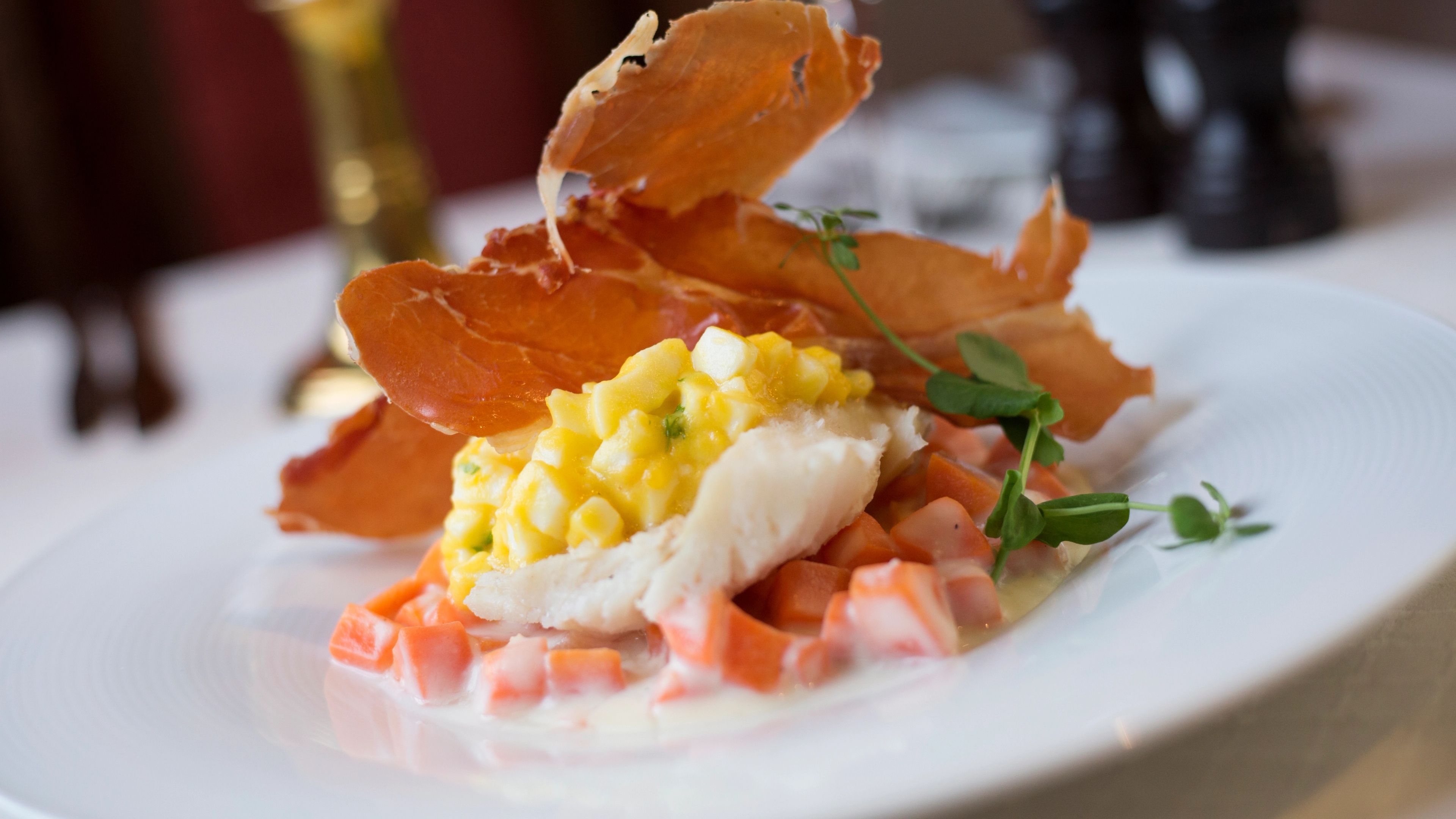 Stockfish with ham and vegetables on a plate in Lofoten, Northern Norway