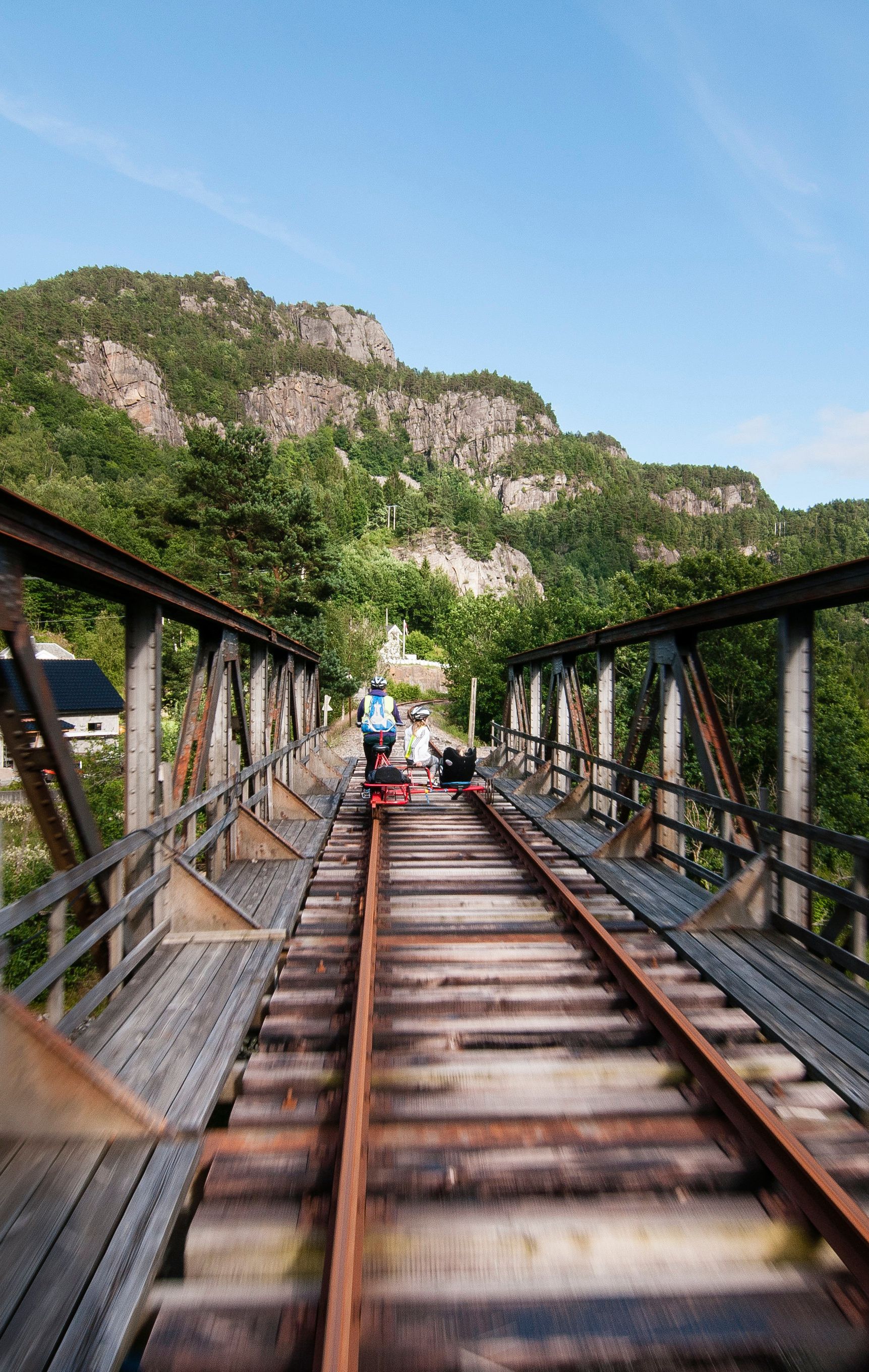 People riding a rail bike in Flekkefjord, Norway