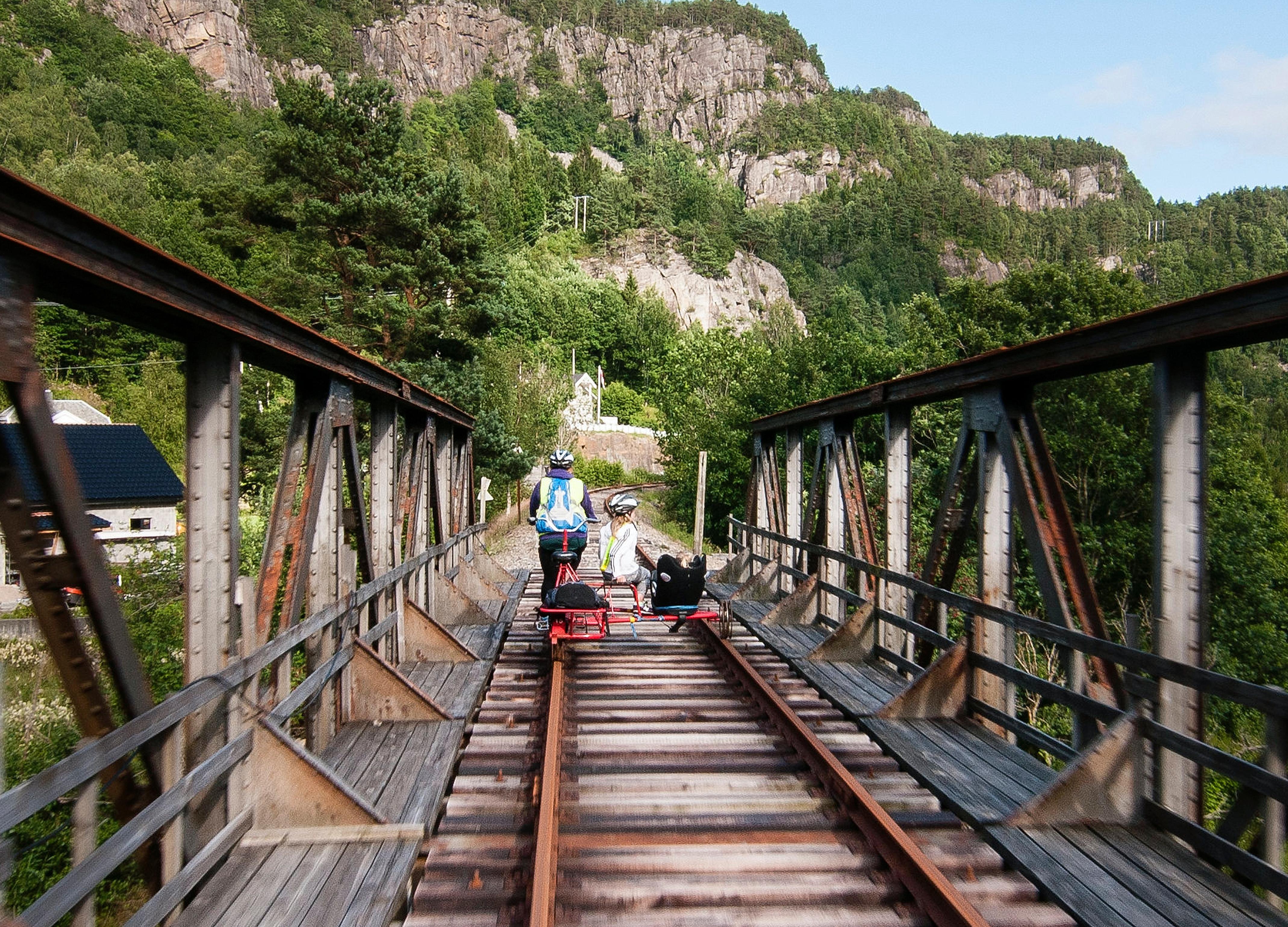 People riding a rail bike in Flekkefjord, Norway