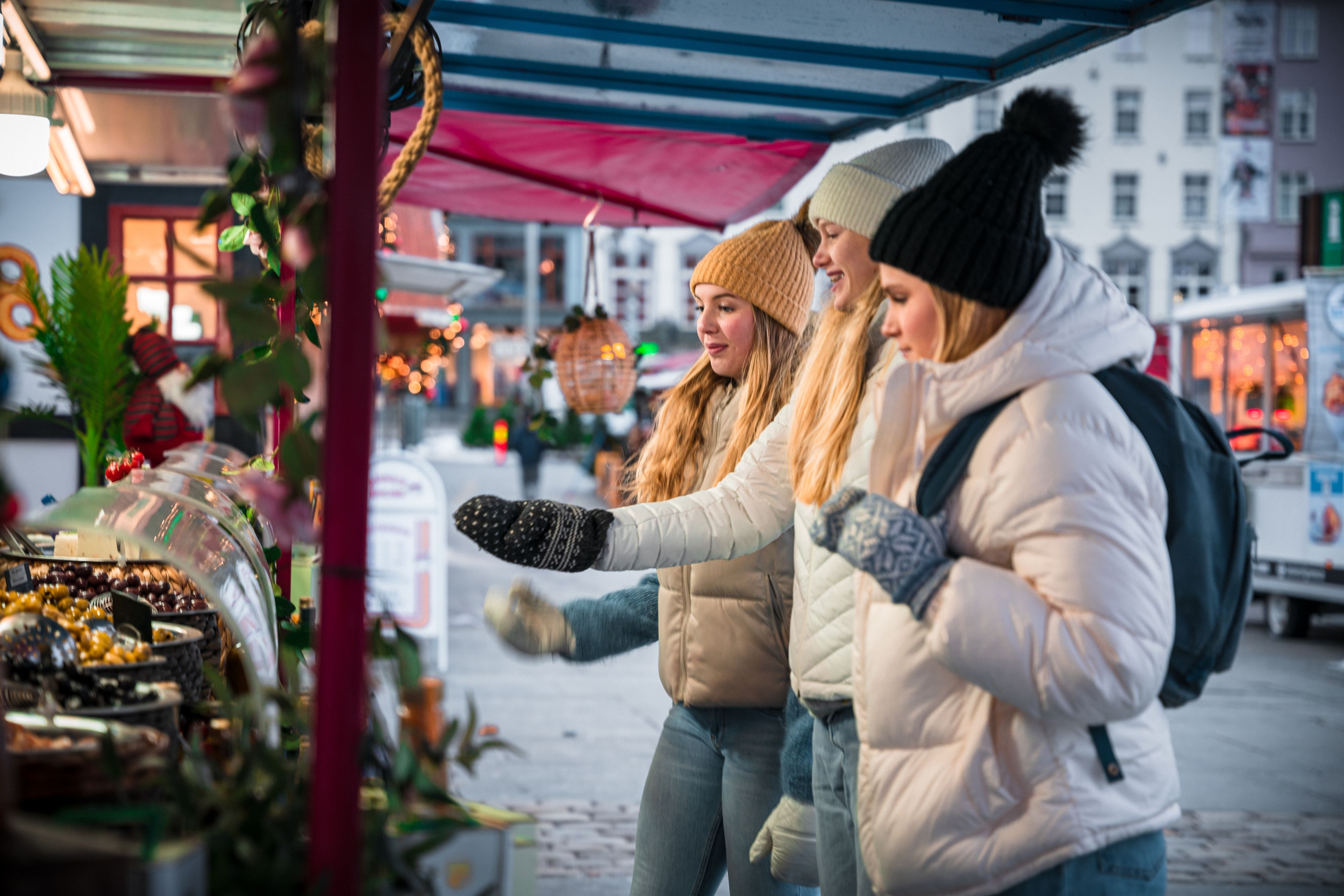 Three girls at the Christmas market in Bergen, Fjord Norway