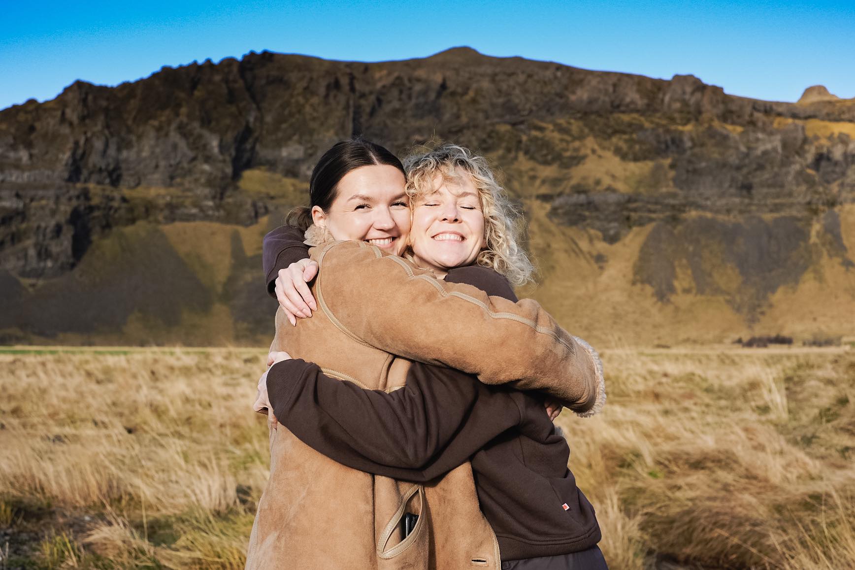 The sisters behind the brand Gobmi hugging each other.