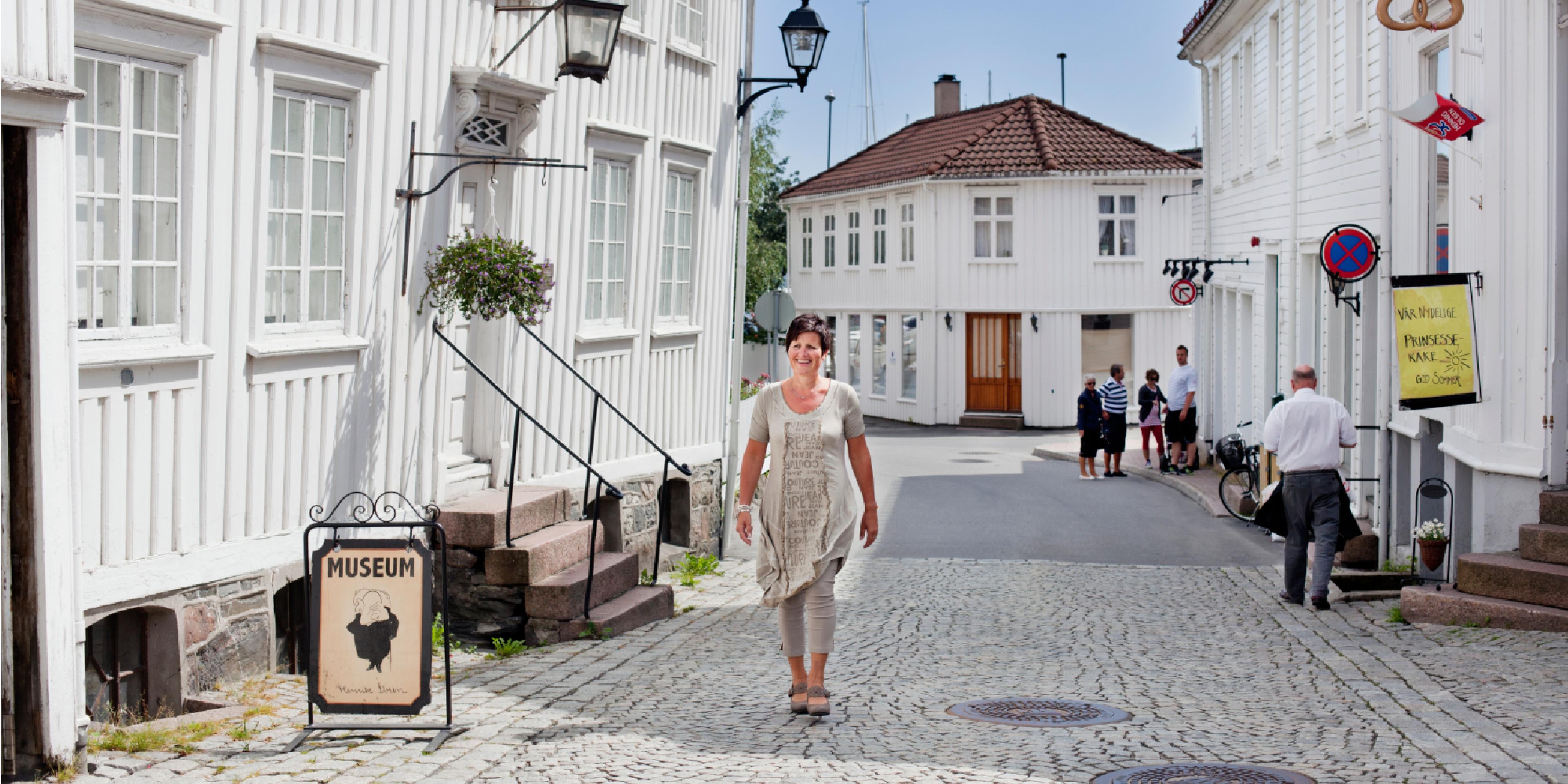 A woman walking past the Ibsen museum in Grimstad in Southern Norway.