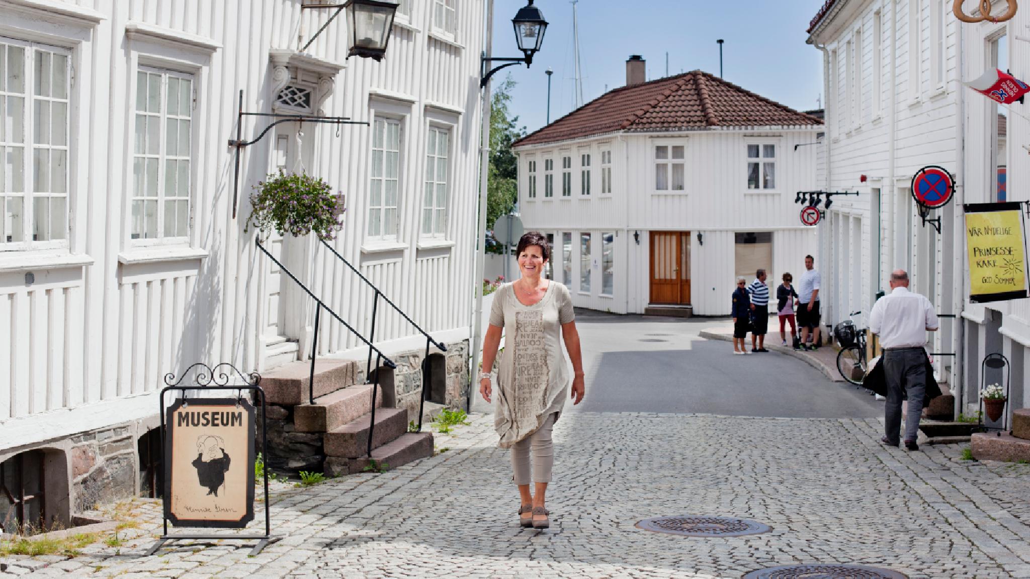A woman walking past the Ibsen museum in Grimstad in Southern Norway.