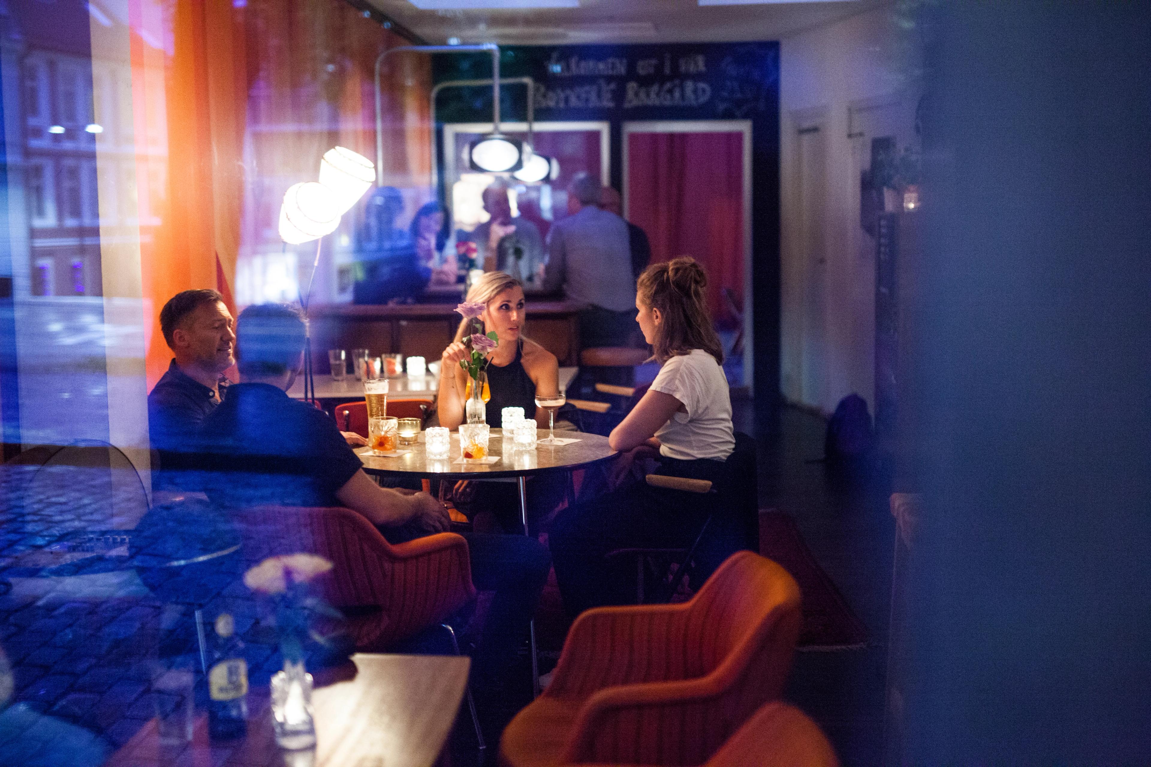 Four people are dining at a restaurant in Bergen in Fjord Norway