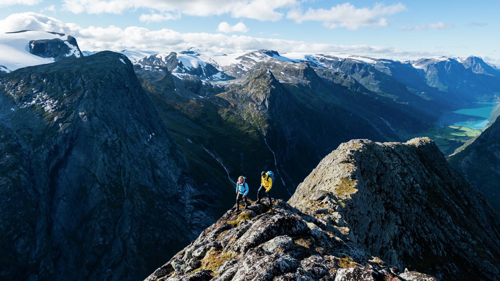 Two people hiking Mount Kattanakken in Jostedalsbreen national park, Fjord Norway