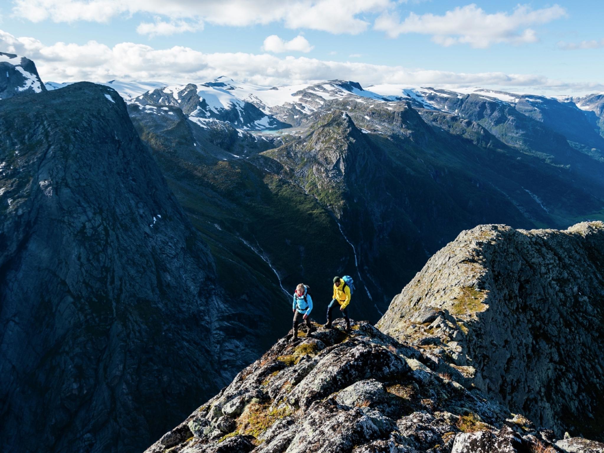 Two people hiking Mount Kattanakken in Jostedalsbreen national park, Fjord Norway