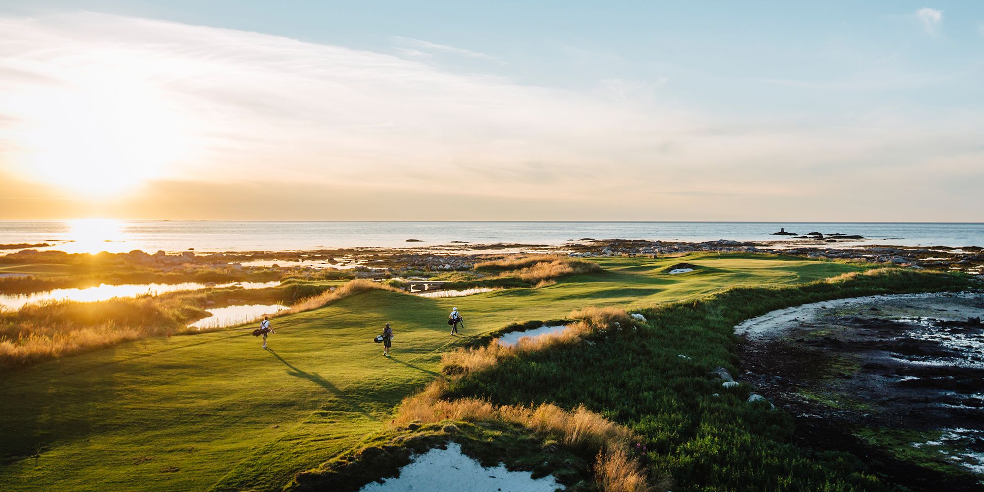 People playing golf under the midnight sun at Lofoten Links in Northern Norway