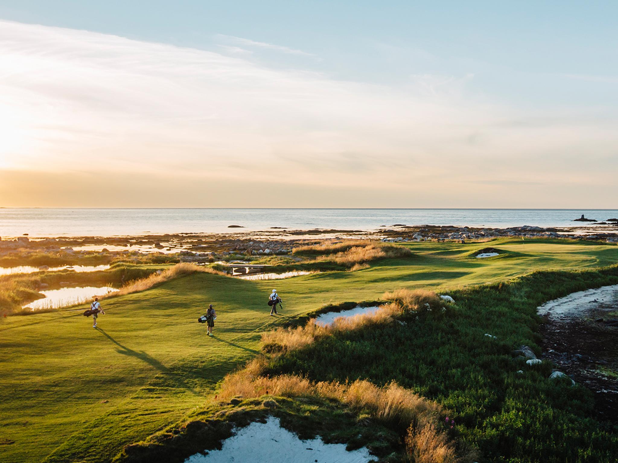 People playing golf under the midnight sun at Lofoten Links in Northern Norway
