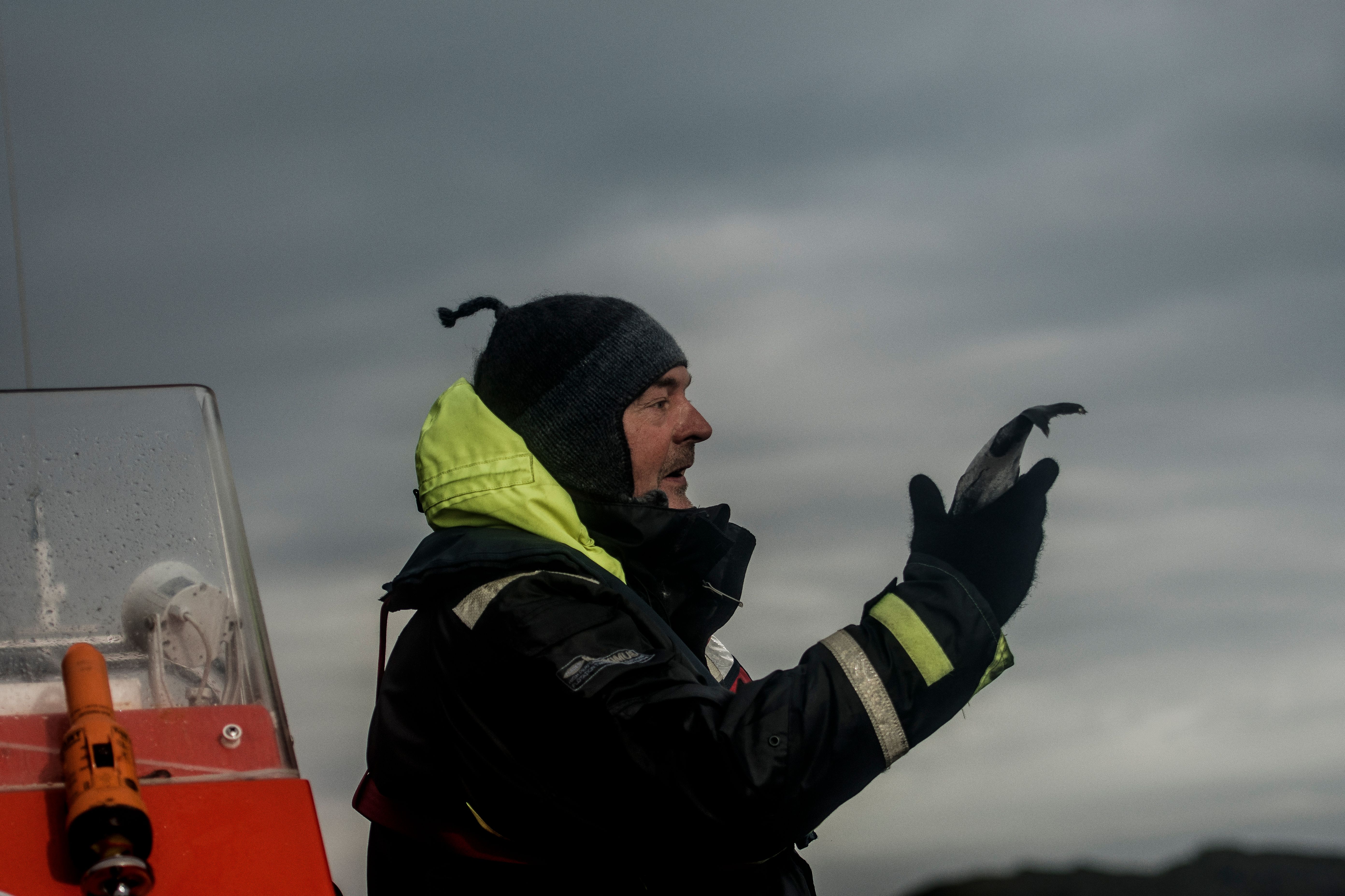 Rolf Malnes from Lofoten Adventure holding a fish on a RIB boat in Henningsvær in Lofoten, Northern Norway