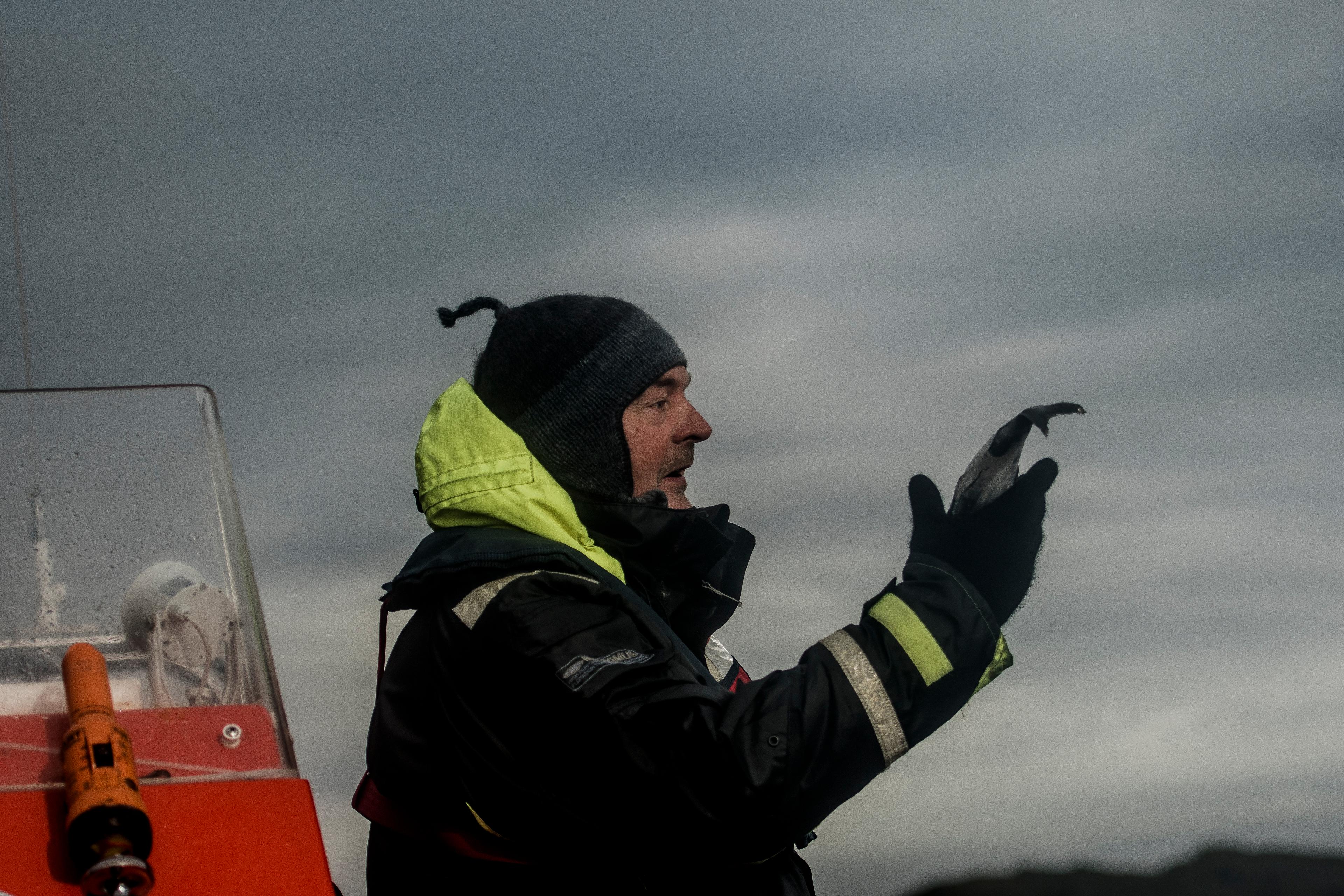 Rolf Malnes from Lofoten Adventure holding a fish on a RIB boat in Henningsvær in Lofoten, Northern Norway