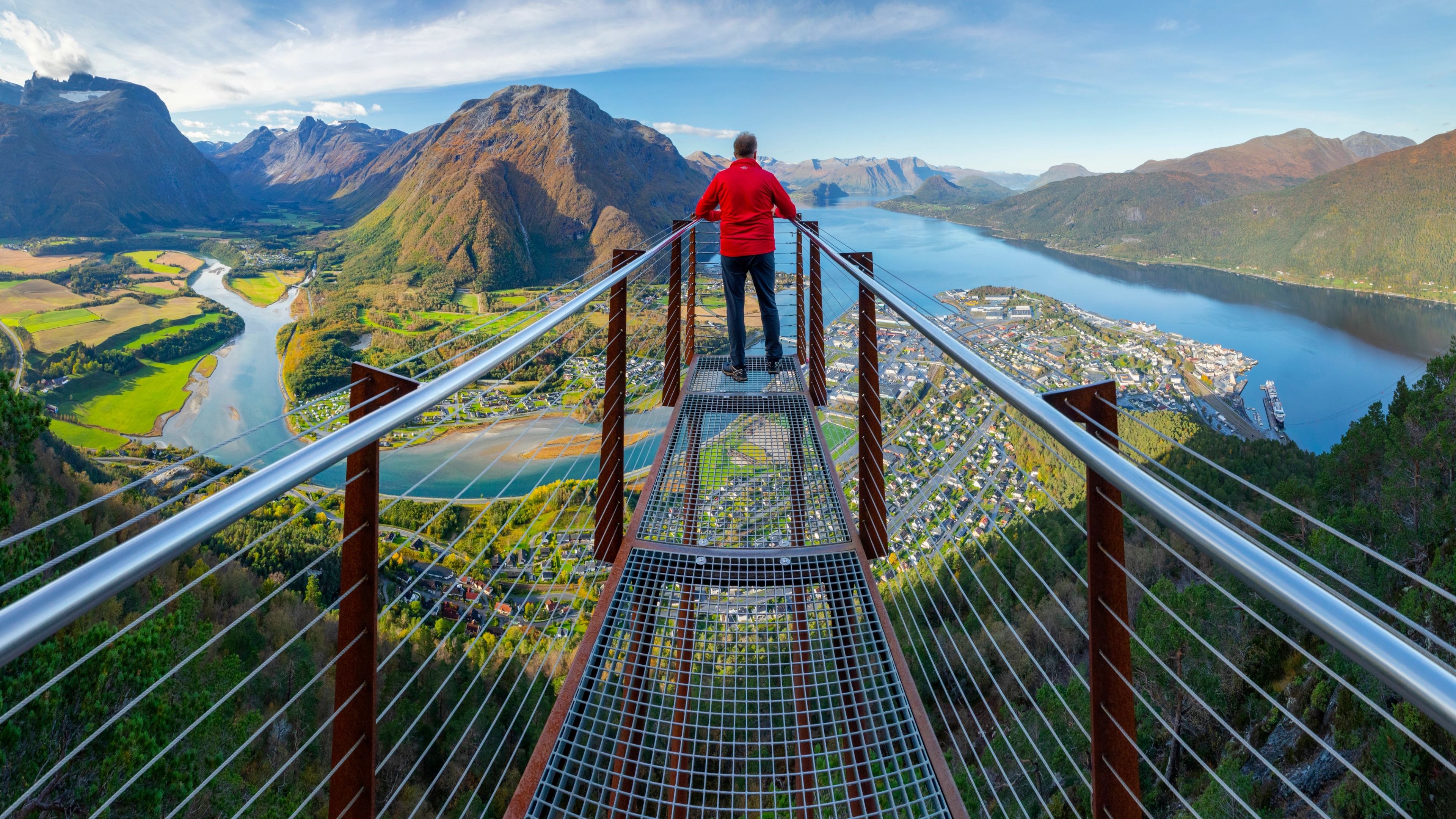 A man standing on top of the Rampestreken viewpoint, Åndalsnes, Western Norway.