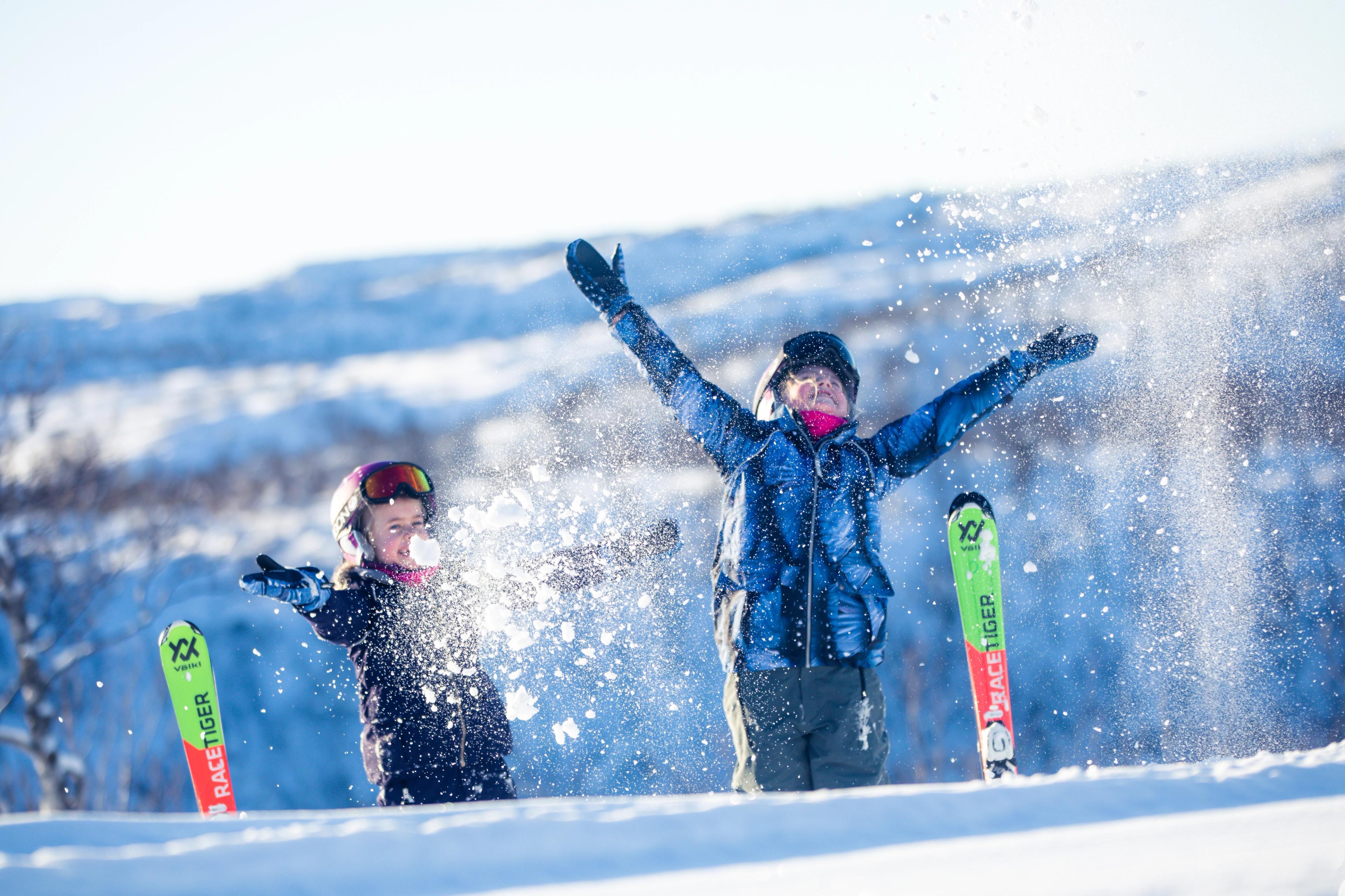 Kids having fun. throwing snow in the air