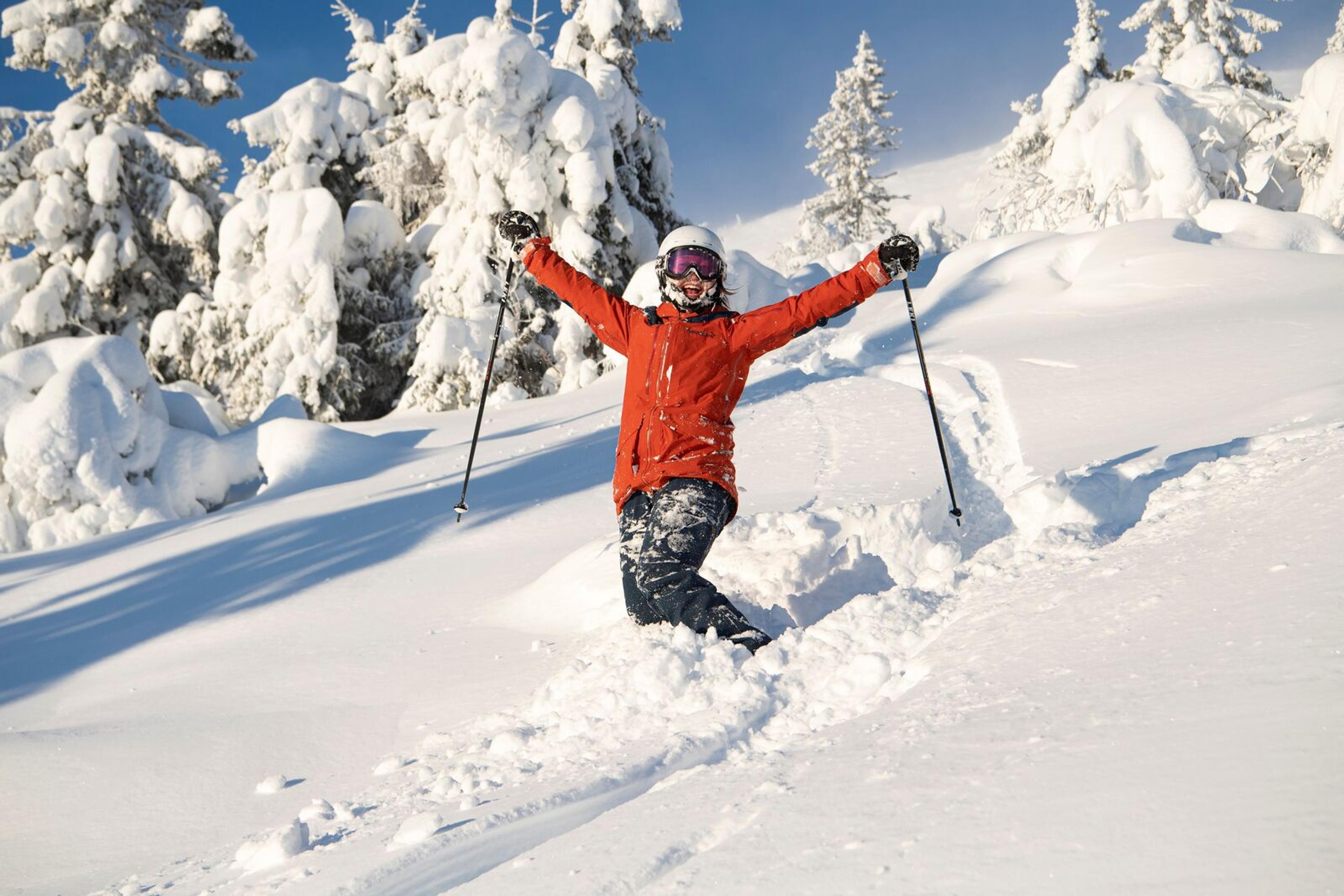 Happy female skier in powder snow in Trysil
