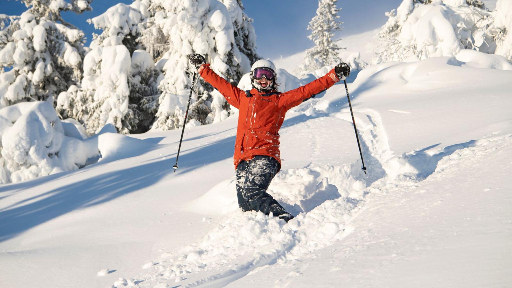 Happy female skier in powder snow in Trysil