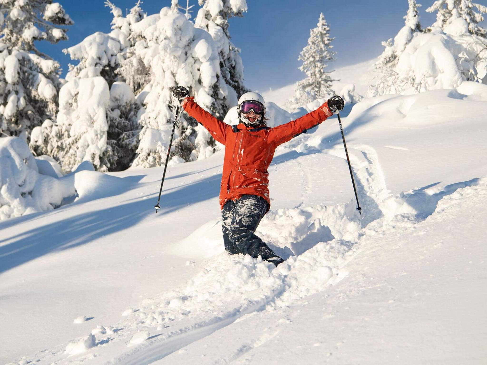 Happy female skier in powder snow in Trysil