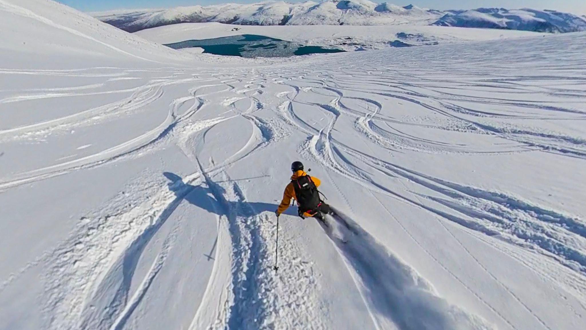 A person cruising down a slope at Galdhøpiggen summer ski centre in Jotunheimen, Eastern Norway