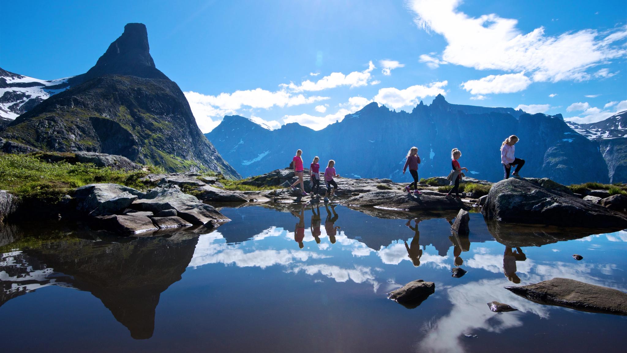 A group of people hiking the Litlefjellet in Åndalsnes in Northwest, Fjord Norway.