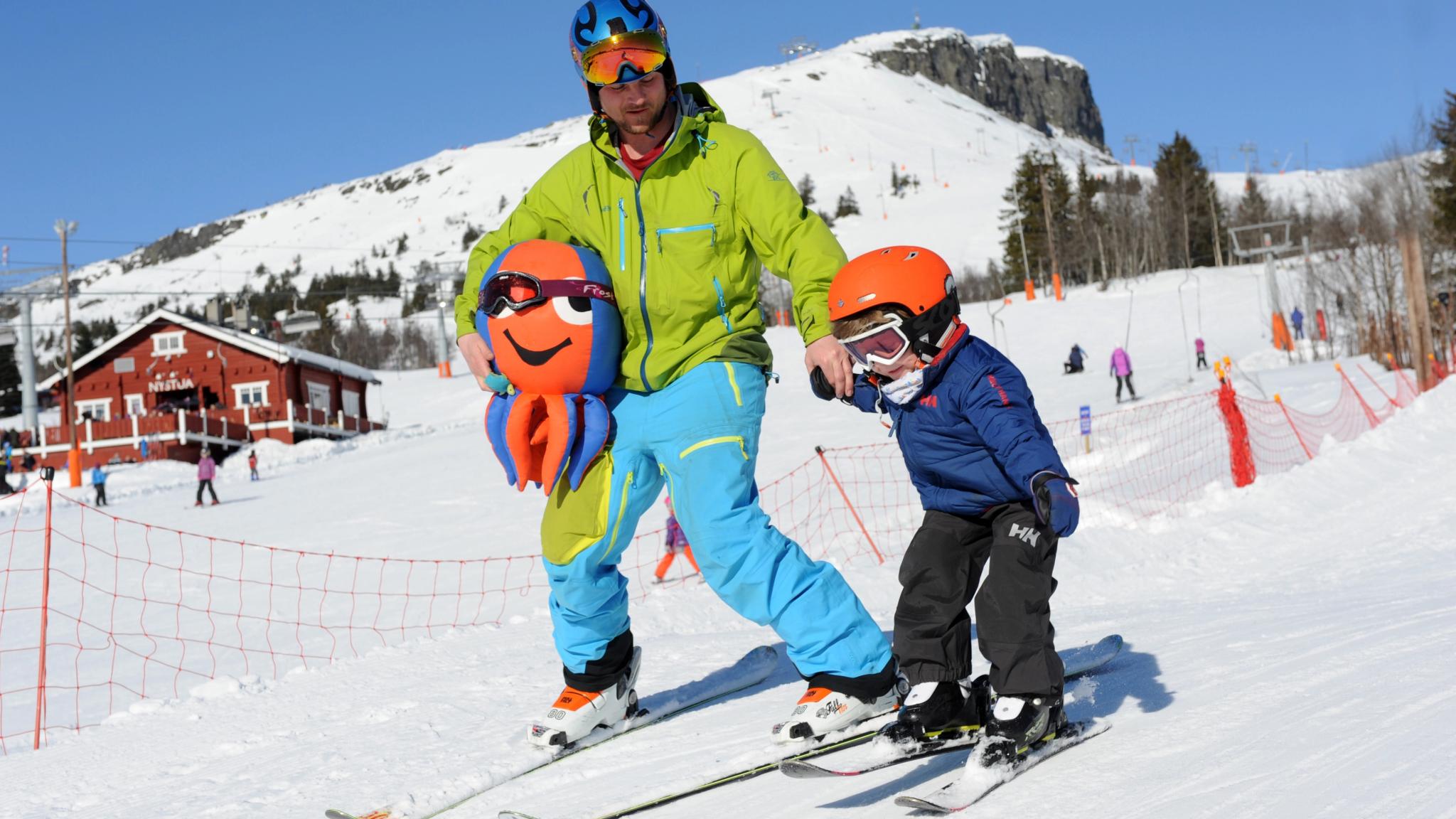 Father and son skiing at Skeikampen ski resort, Eastern Norway