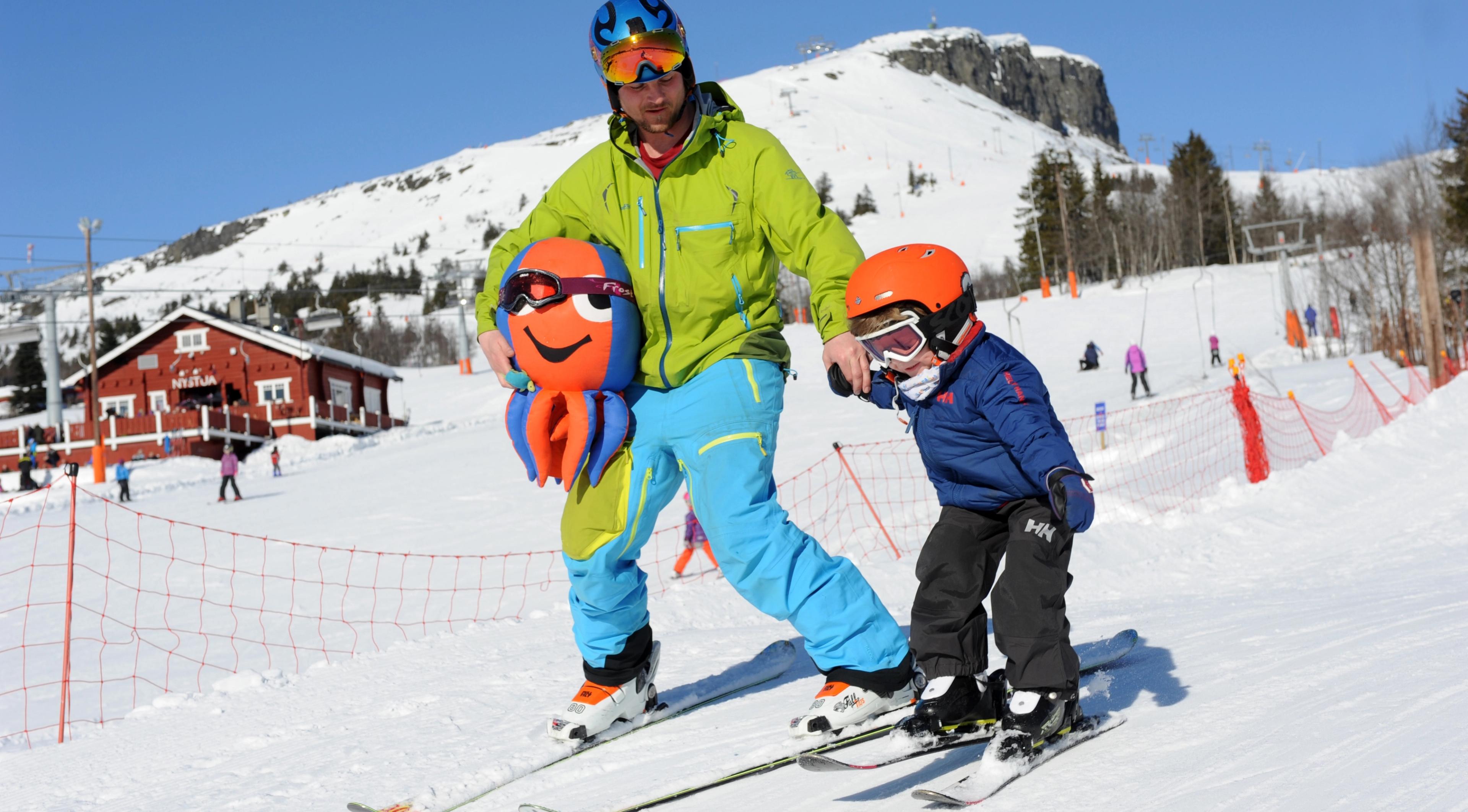 Father and son skiing at Skeikampen ski resort, Eastern Norway