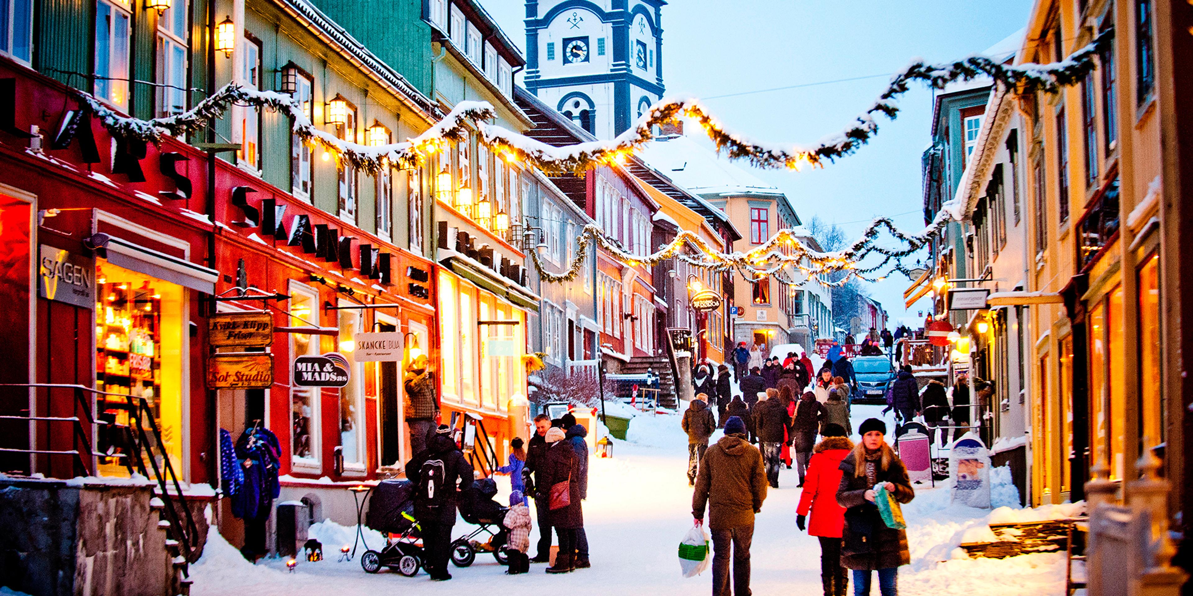 People walking in the snowy street during a Christmas market in Røros in Trøndelag, Norway