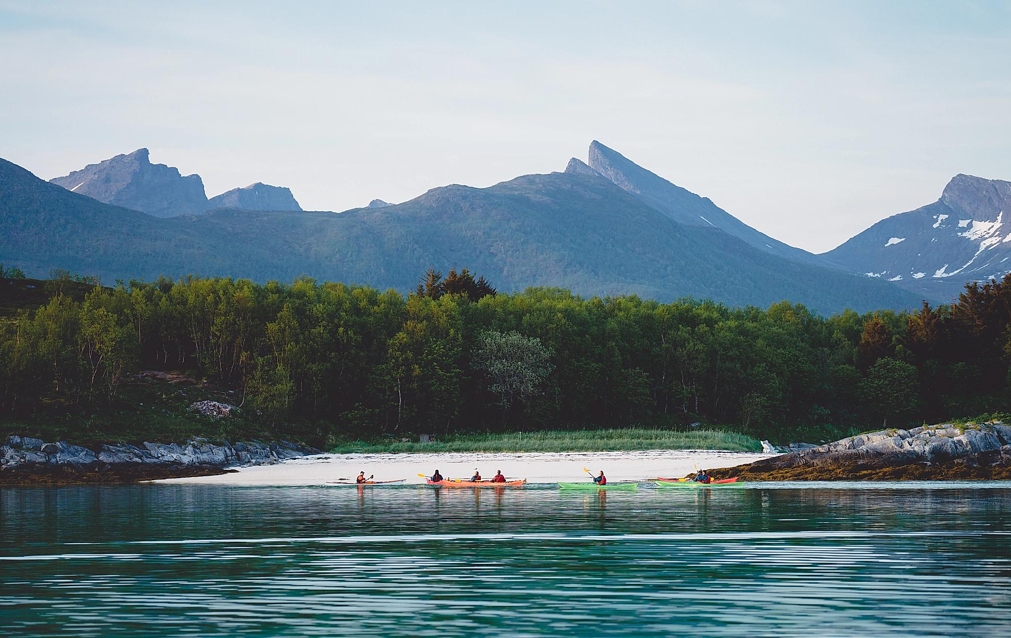 People kayaking in Senja, Troms, Northern Norway.