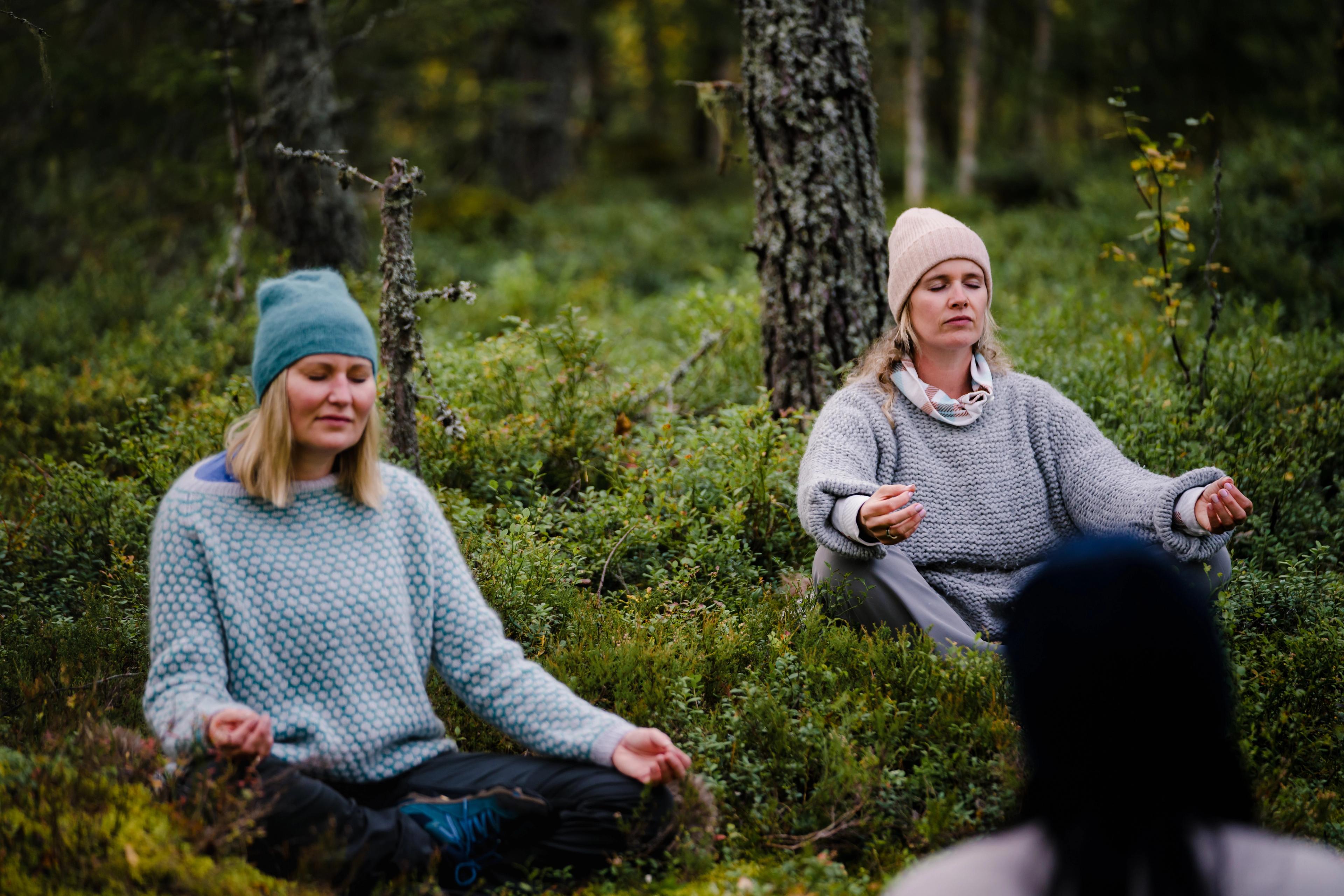 Two women meditation in the Finnskogen forest in Hedmark county