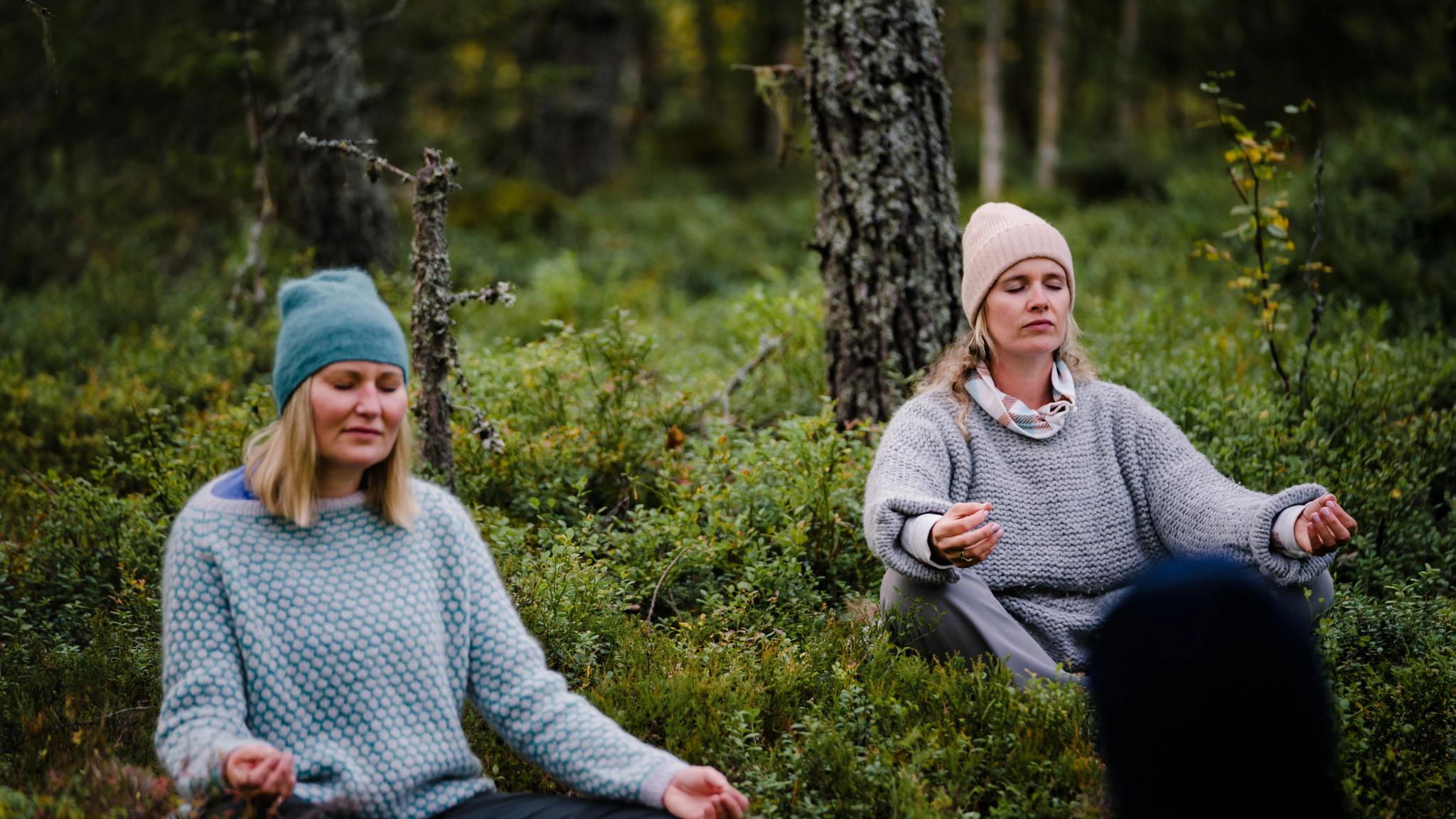 Two women meditation in the Finnskogen forest in Hedmark county