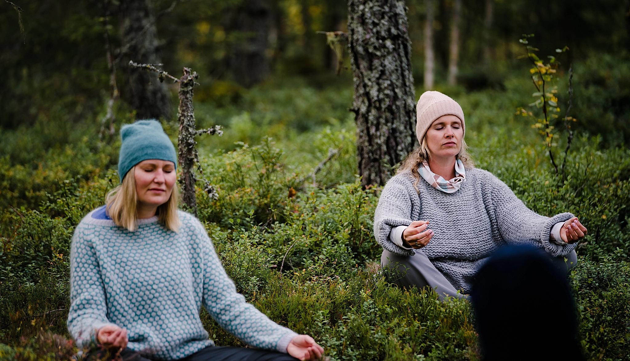 Two women meditation in the Finnskogen forest in Hedmark county
