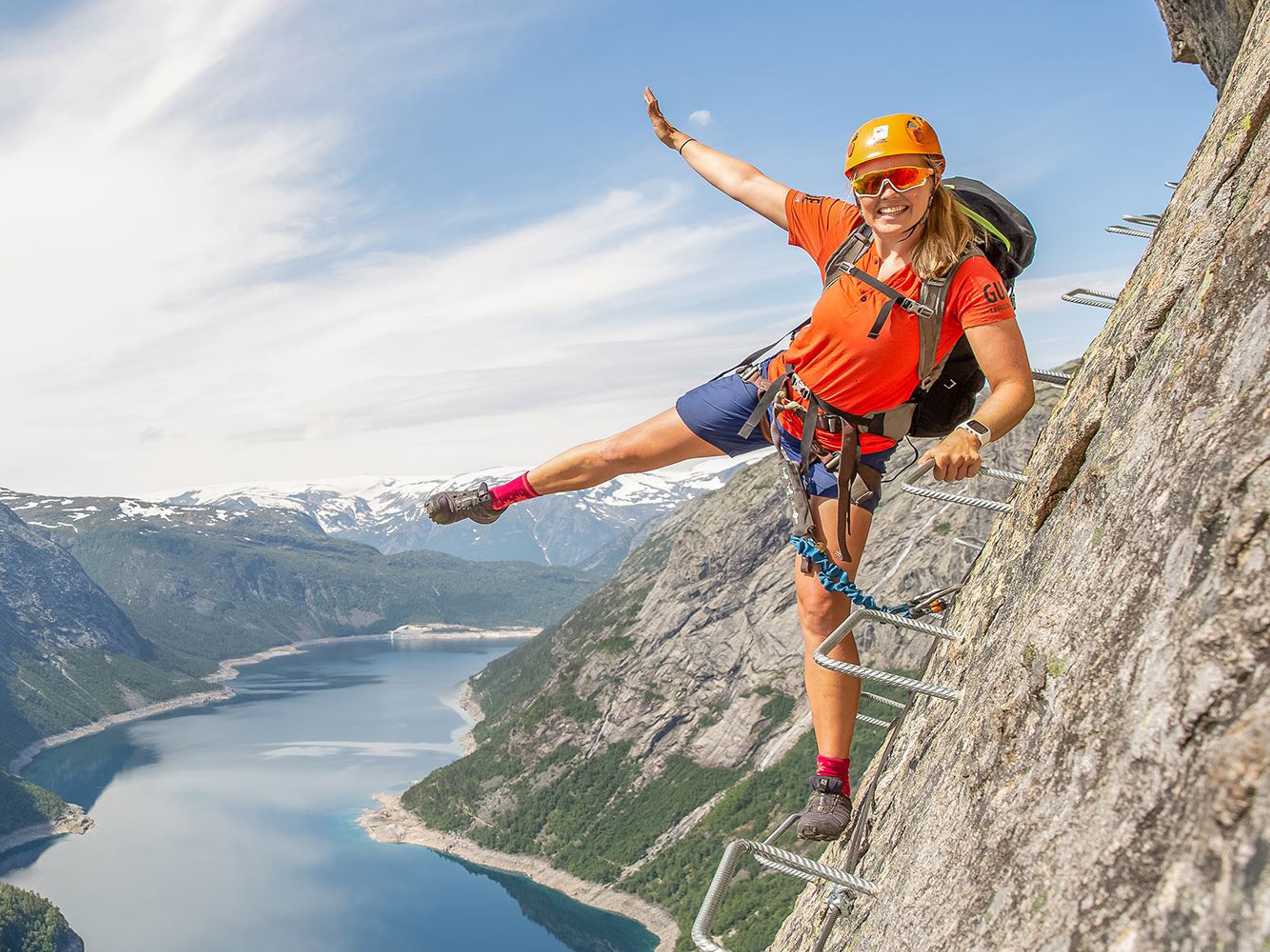 Active holiday in Norway: Woman climbing the Trolltunga via ferrata in Fjord Norway