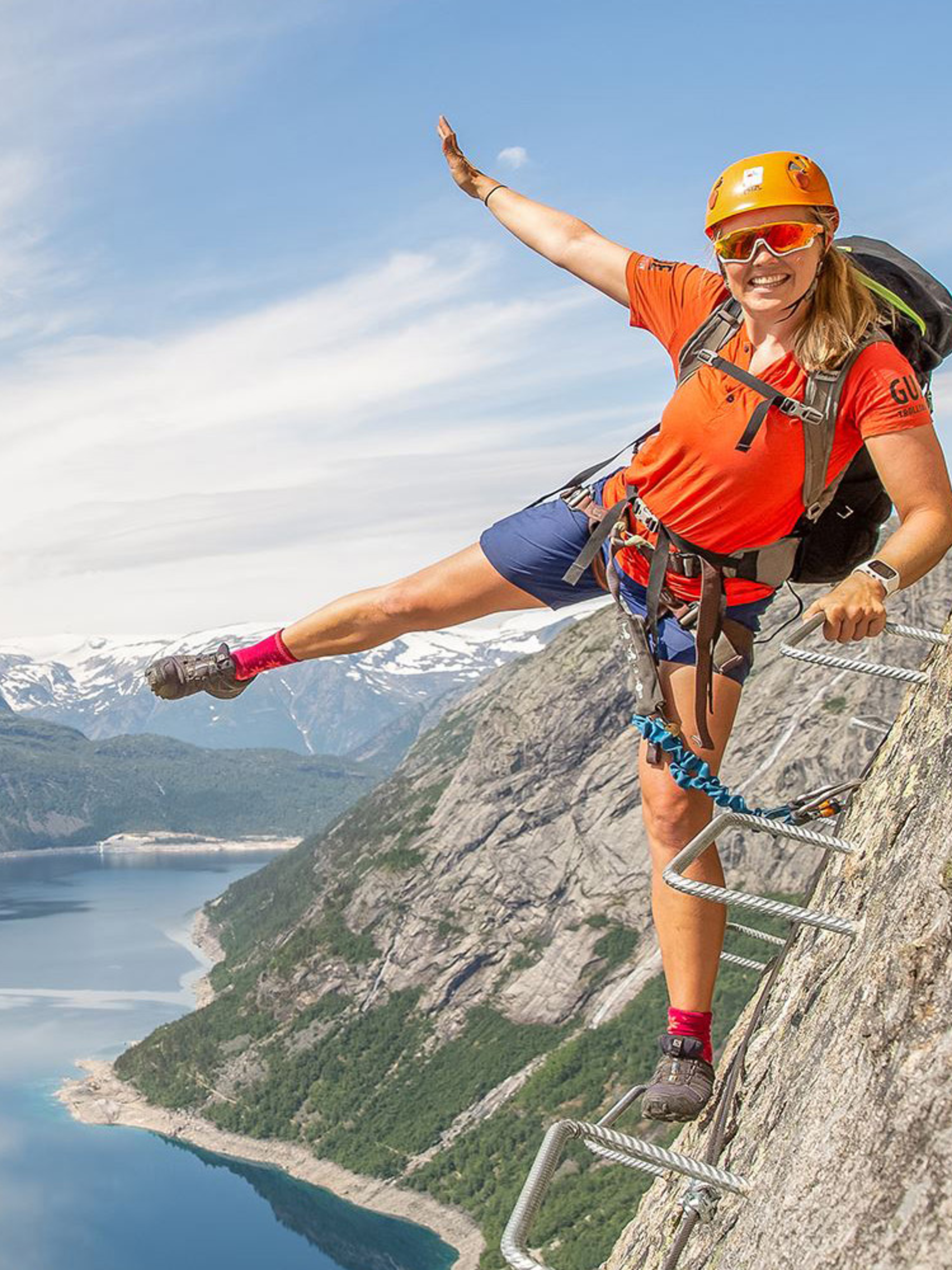 Active holiday in Norway: Woman climbing the Trolltunga via ferrata in Fjord Norway