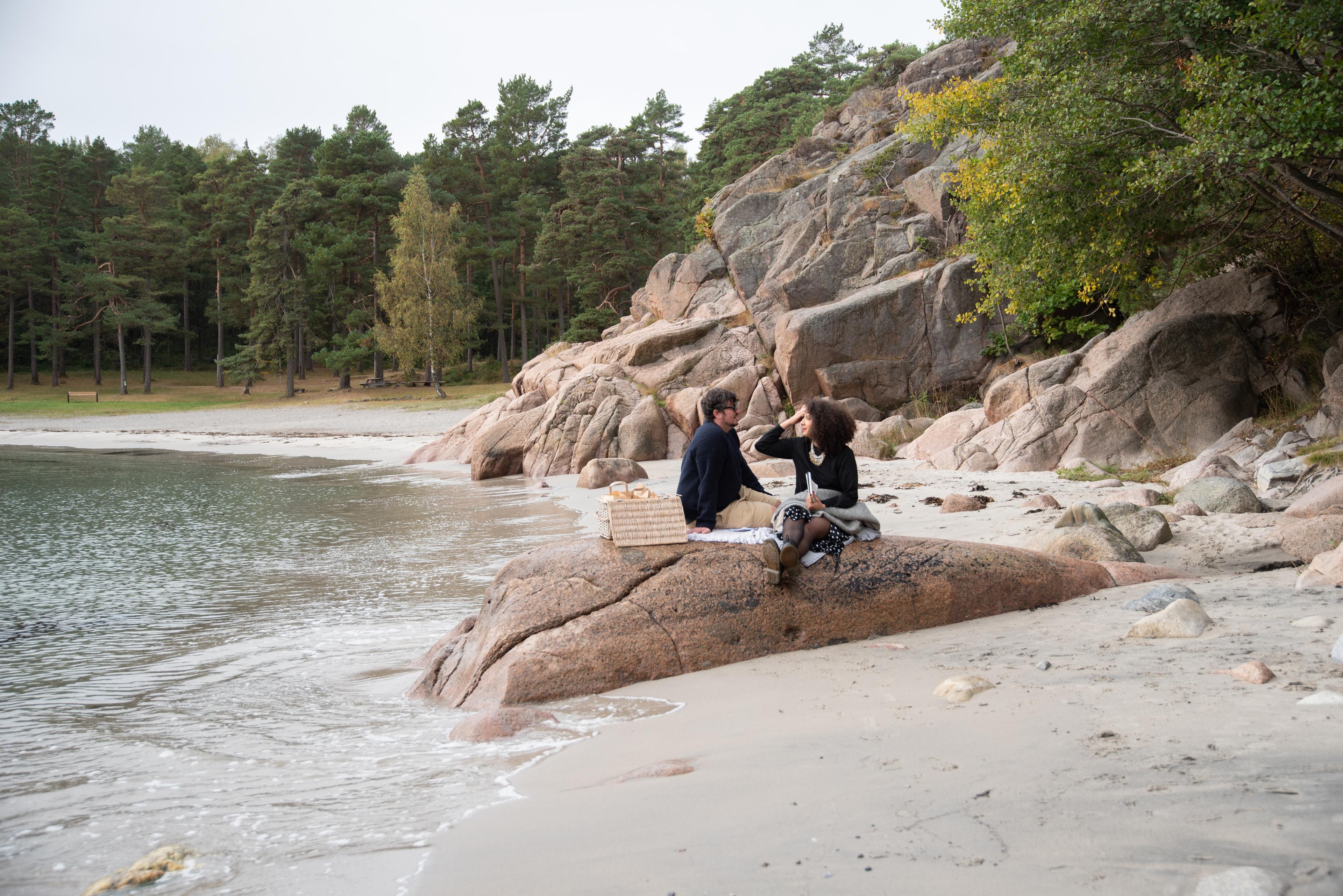 Couple sitting on the skerries in Southern Norway
