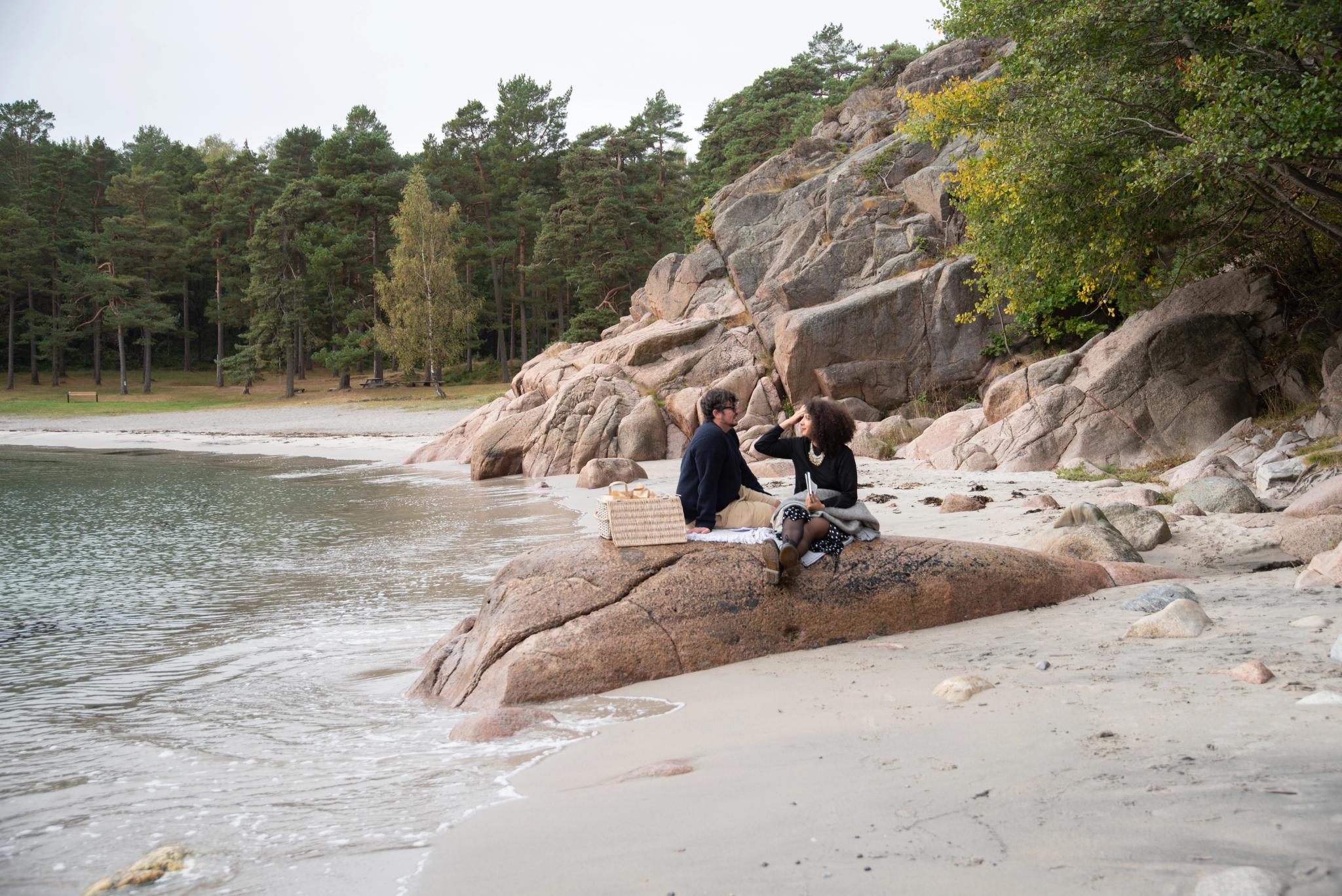 Couple sitting on the skerries in Southern Norway