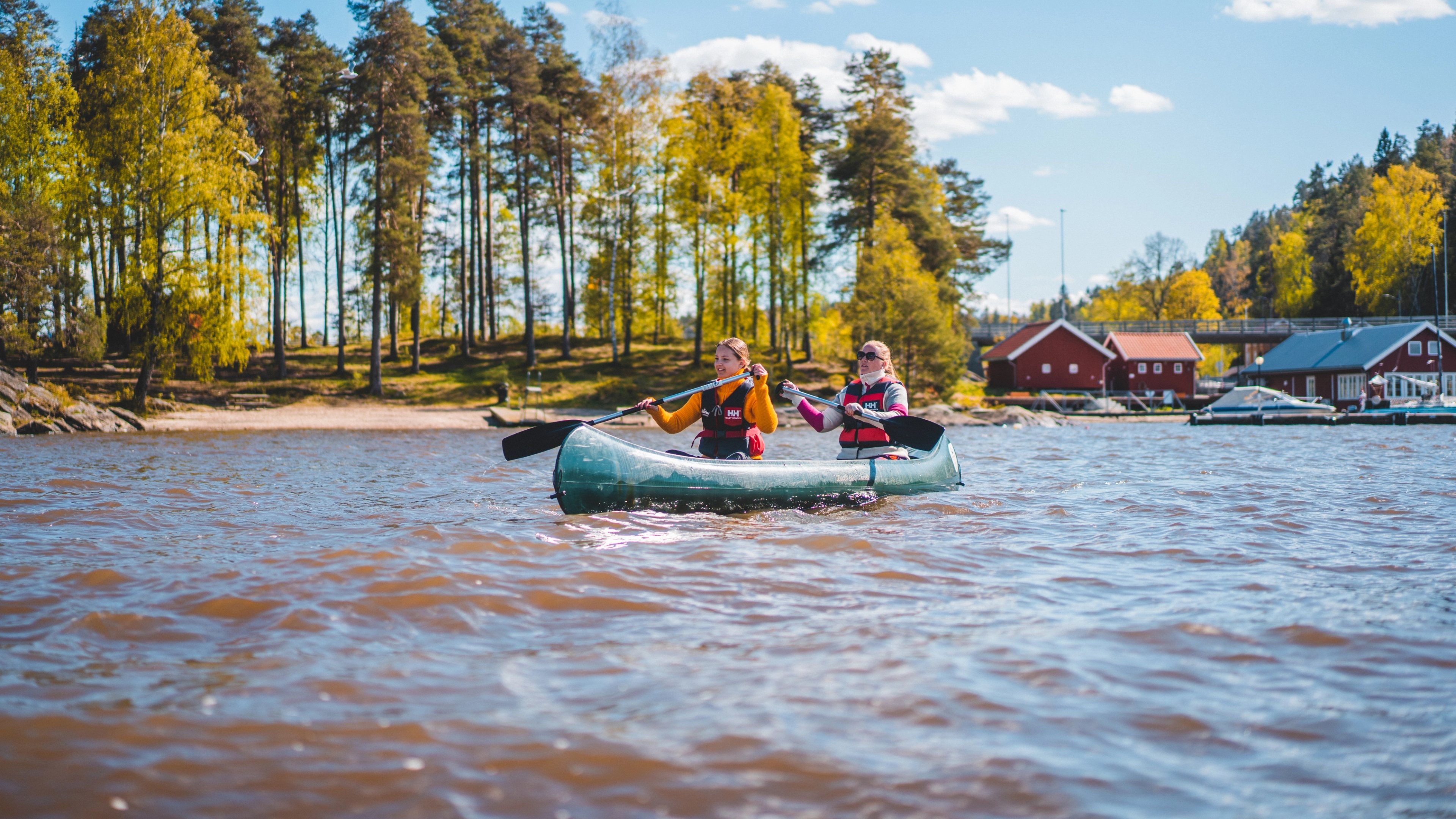 Folk padler i kano på en innsjø i Indre Østfold på Østlandet